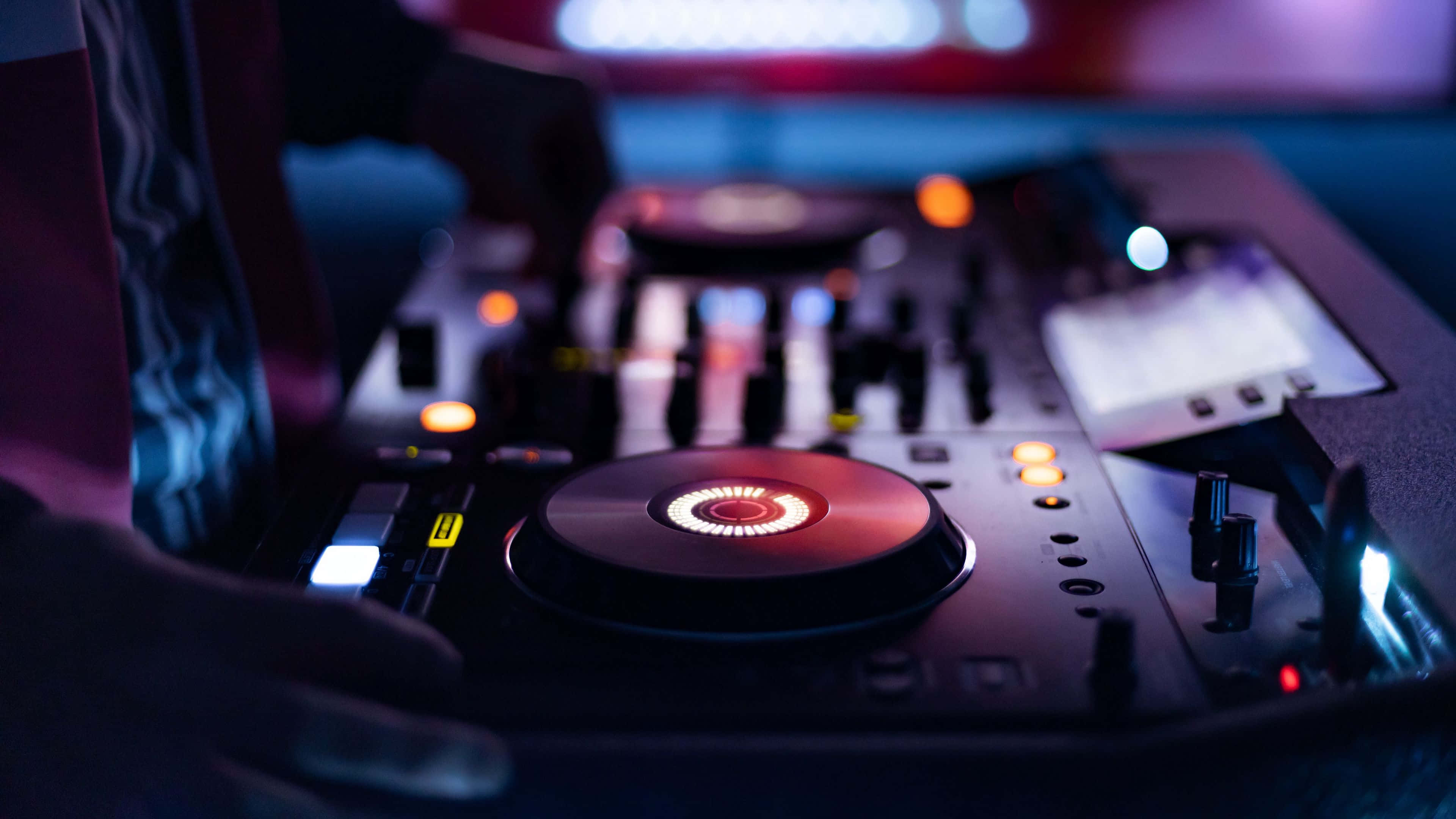 DJ mixer, neon lights, dim nightclub setting, 4K Desktop Wallpaper