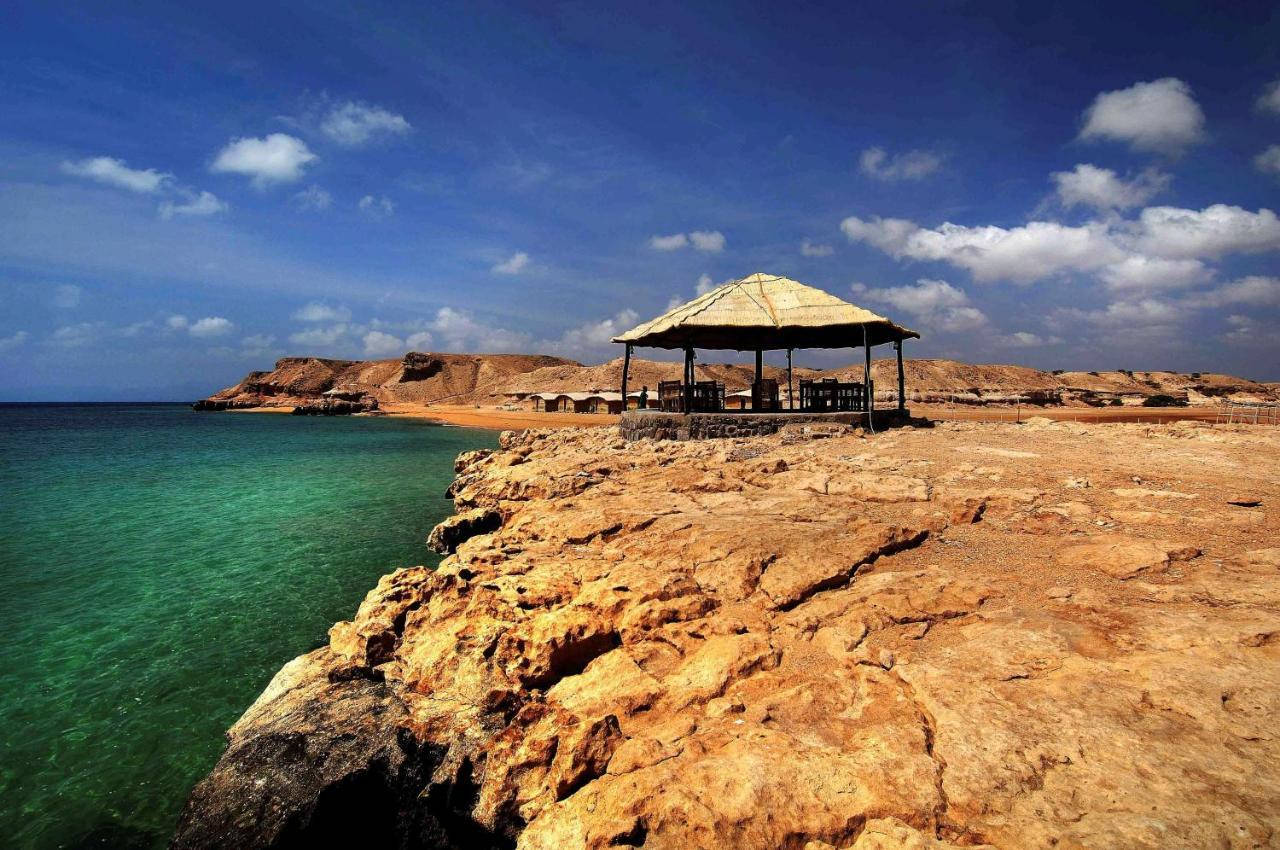 Djibouti, thatched-roof gazebo, rugged golden cliffs, HD Desktop Wallpaper