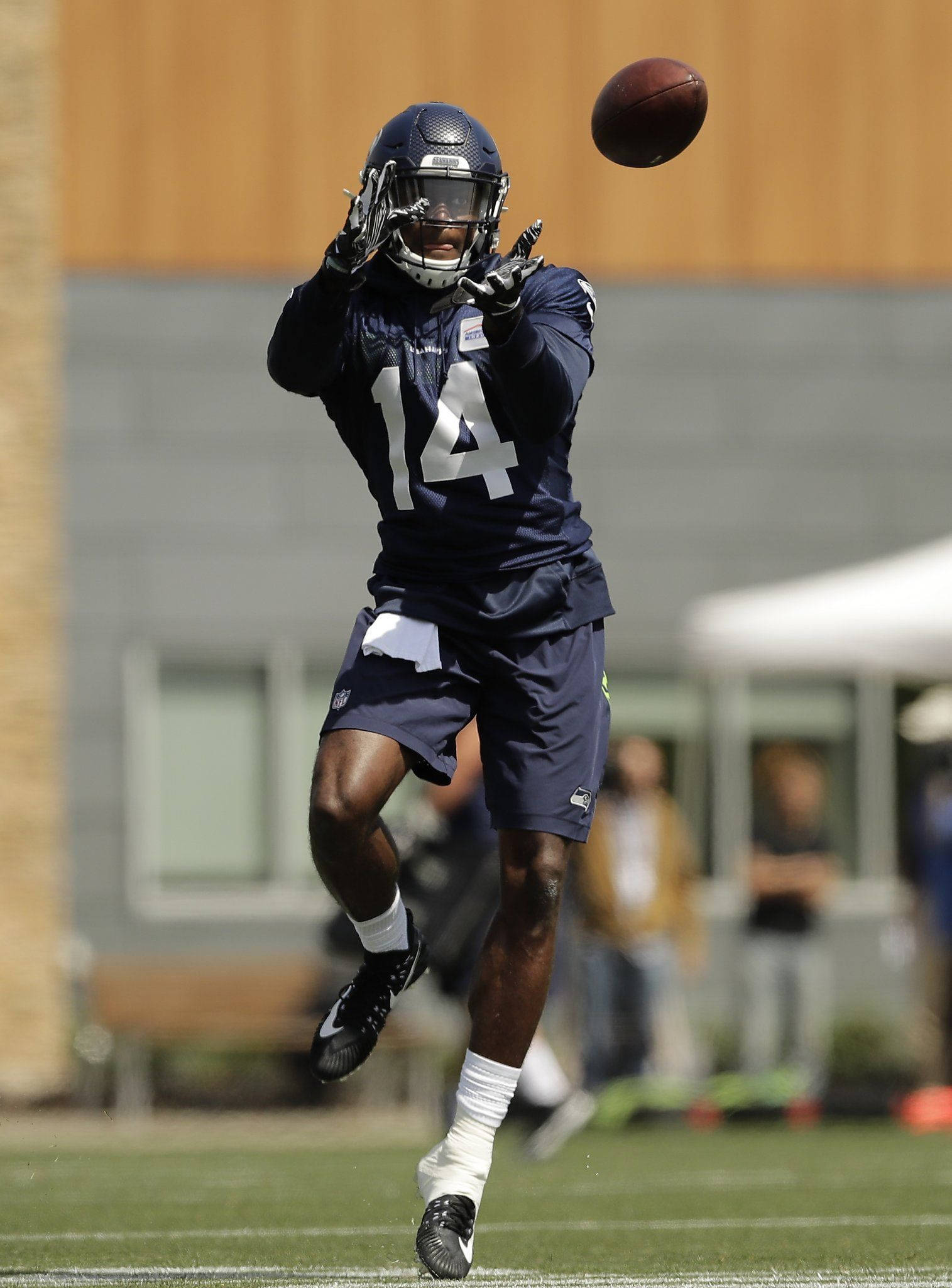 DK Metcalf, navy uniform, brown football, Full HD Phone Wallpaper
