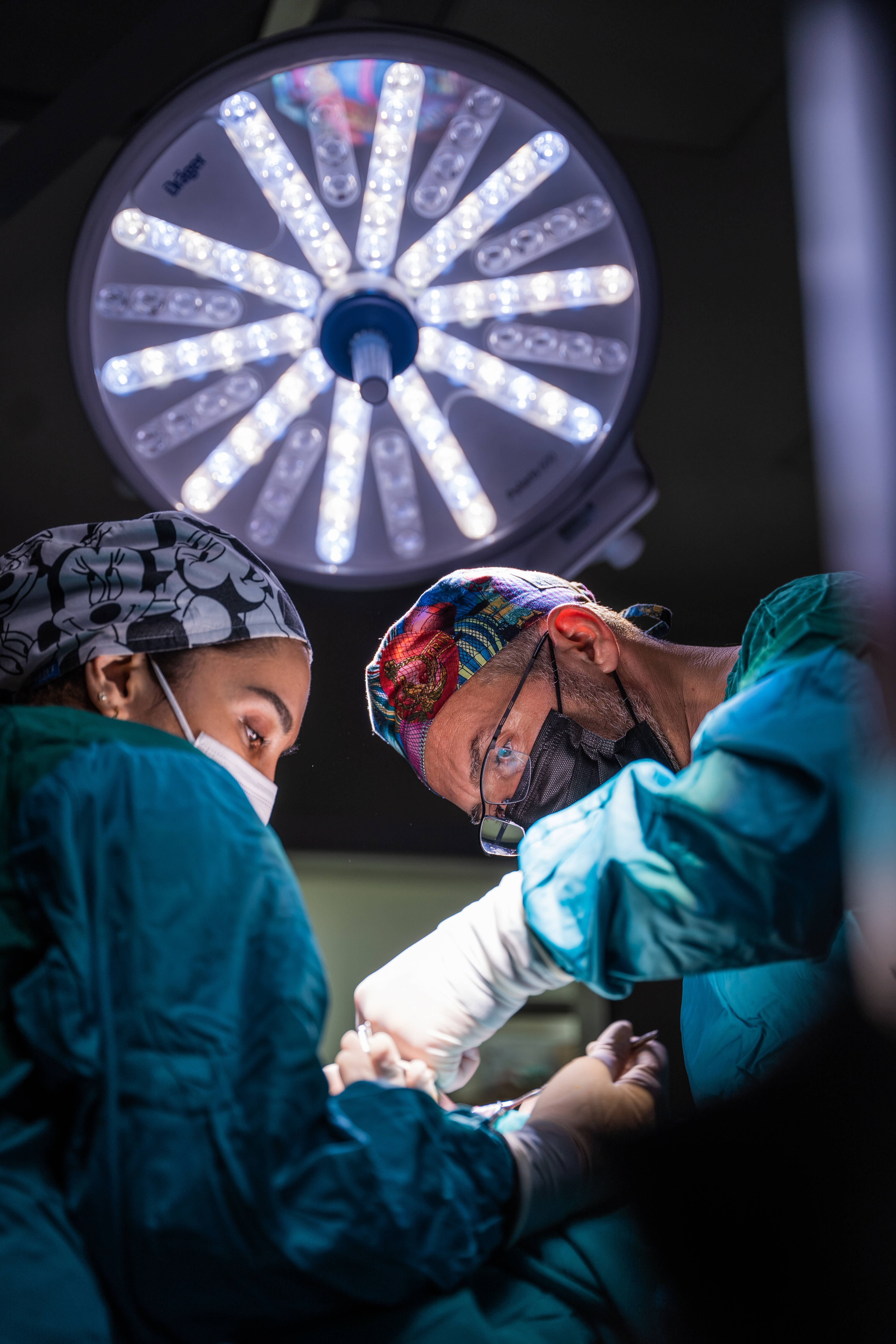 teal scrubs, patterned caps, bright surgical light, 5K Phone Wallpaper