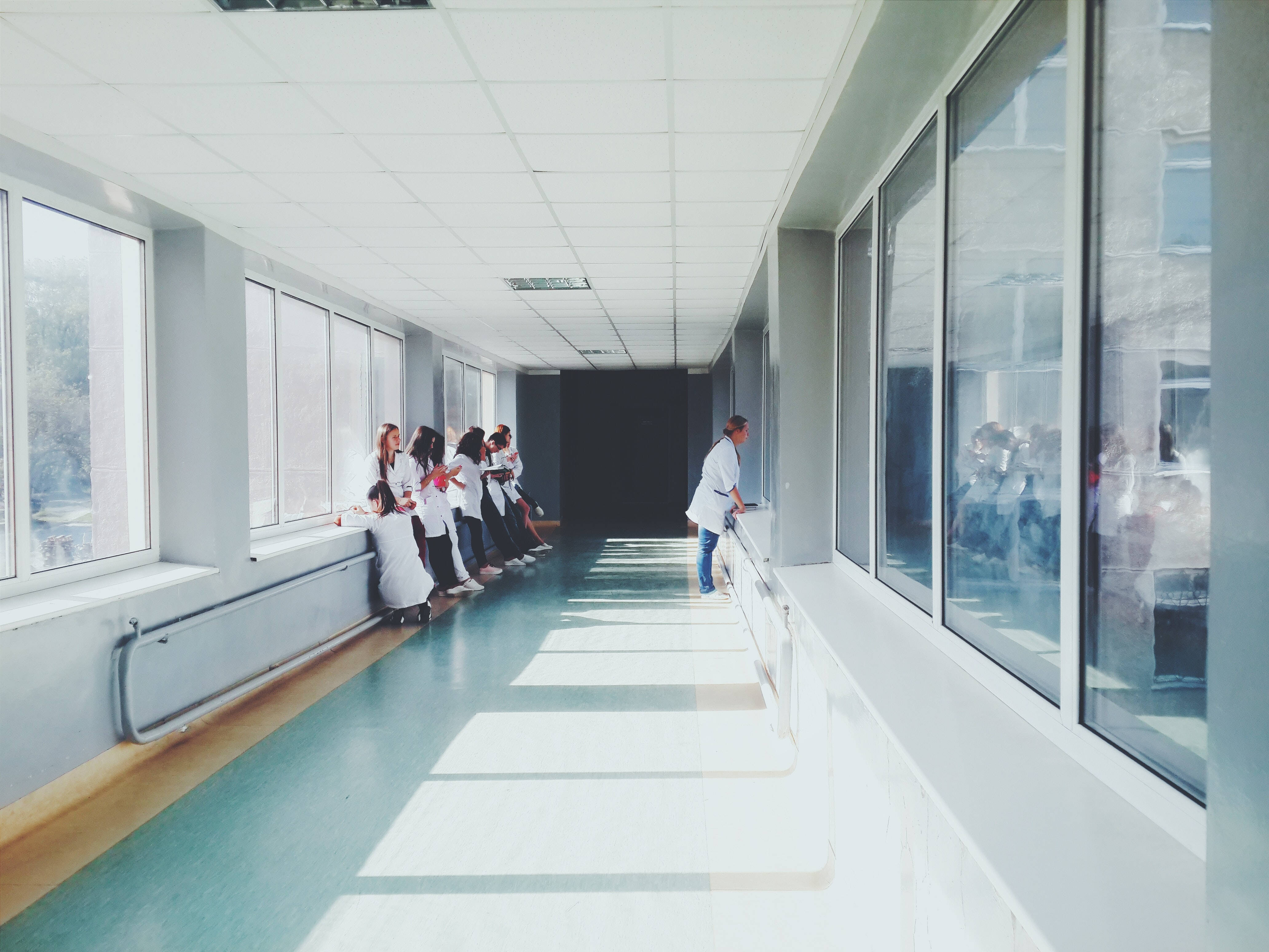 Doctors, white coats, sunlit hospital corridor, 4K Desktop Wallpaper