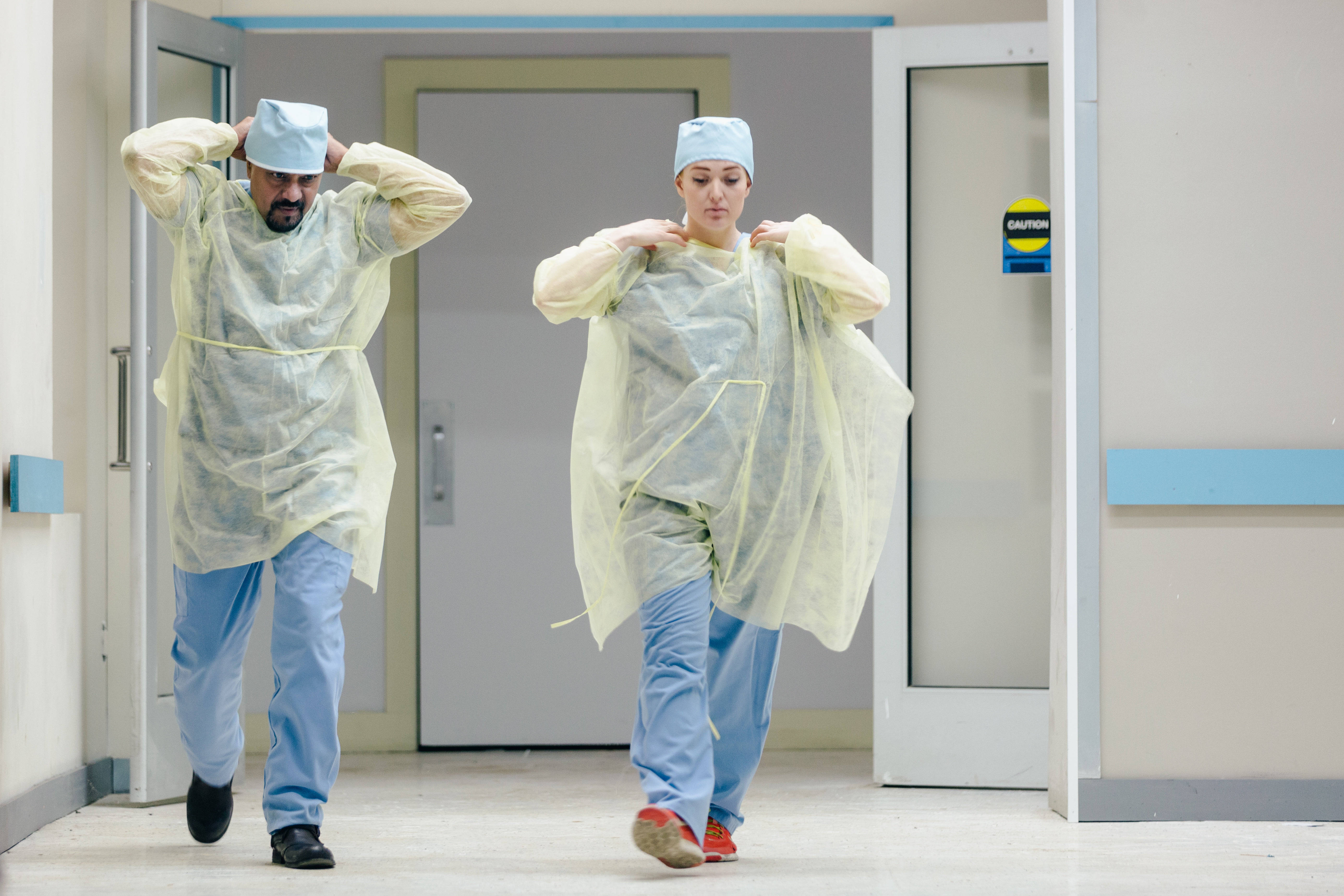 light yellow surgical gowns, blue scrubs, sterile hospital corridor, 5K Desktop Wallpaper