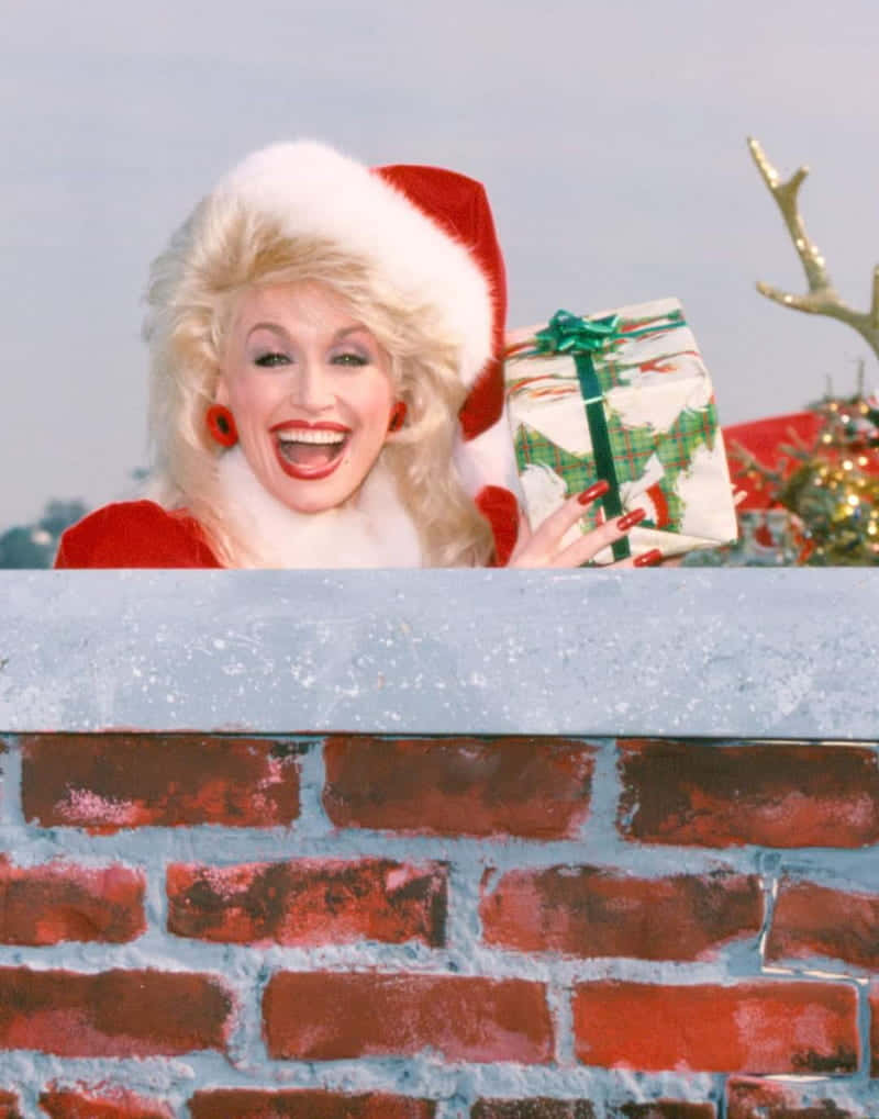 Dolly Parton, Santa hat, snowy brick chimney, SD Phone Wallpaper