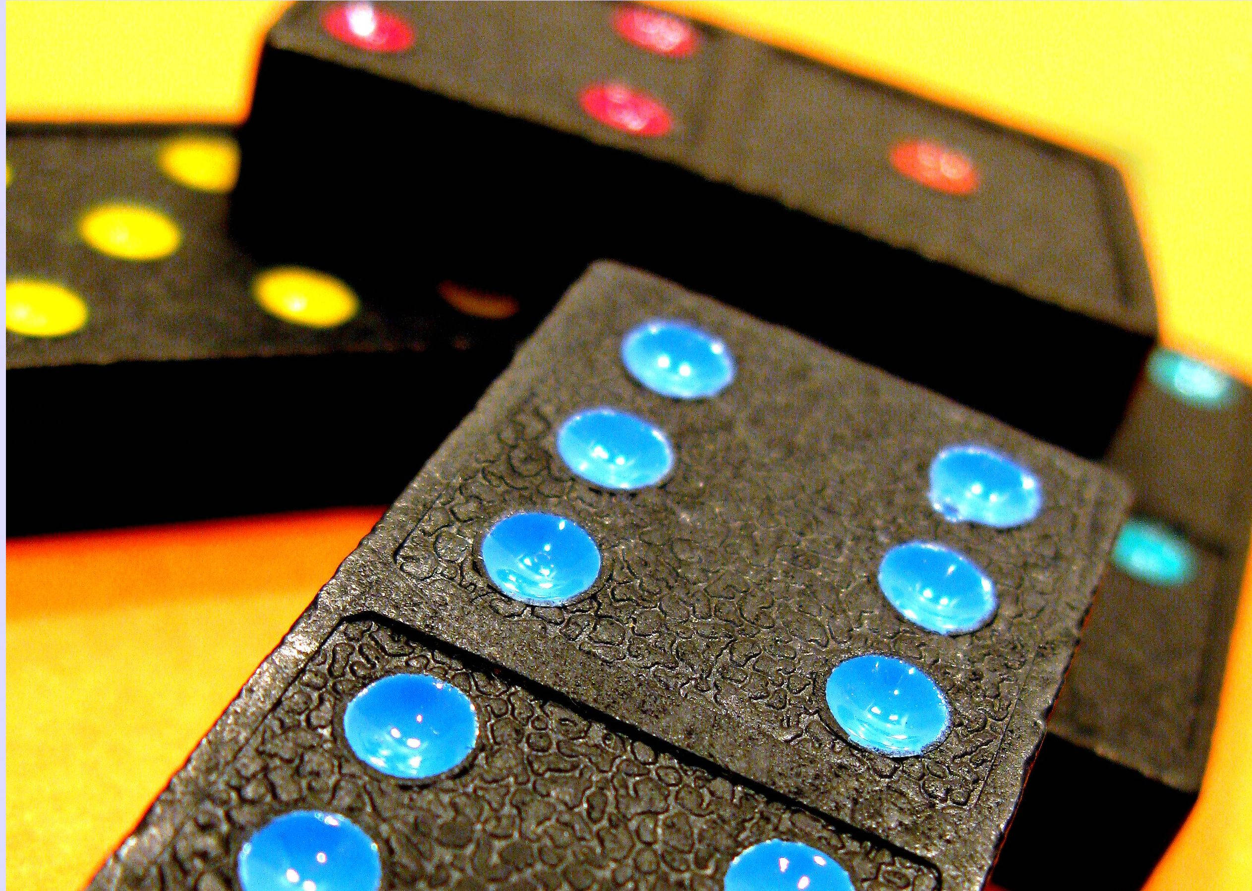 glossy black dominoes, blue yellow and red pips, warm gradient background, Full HD Desktop Wallpaper