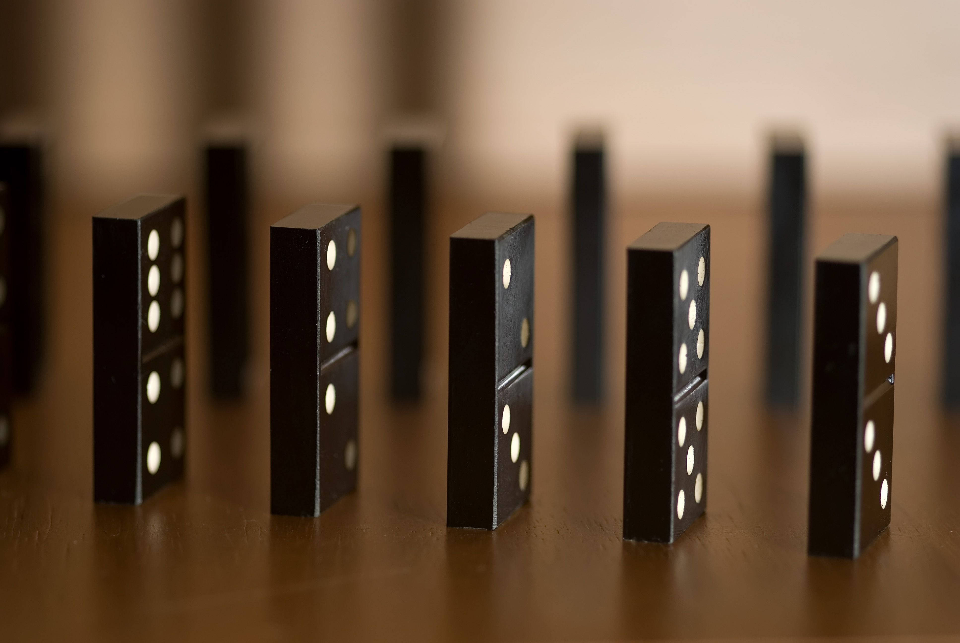 black dominoes, white dots, warm wooden surface, 4K Desktop Wallpaper