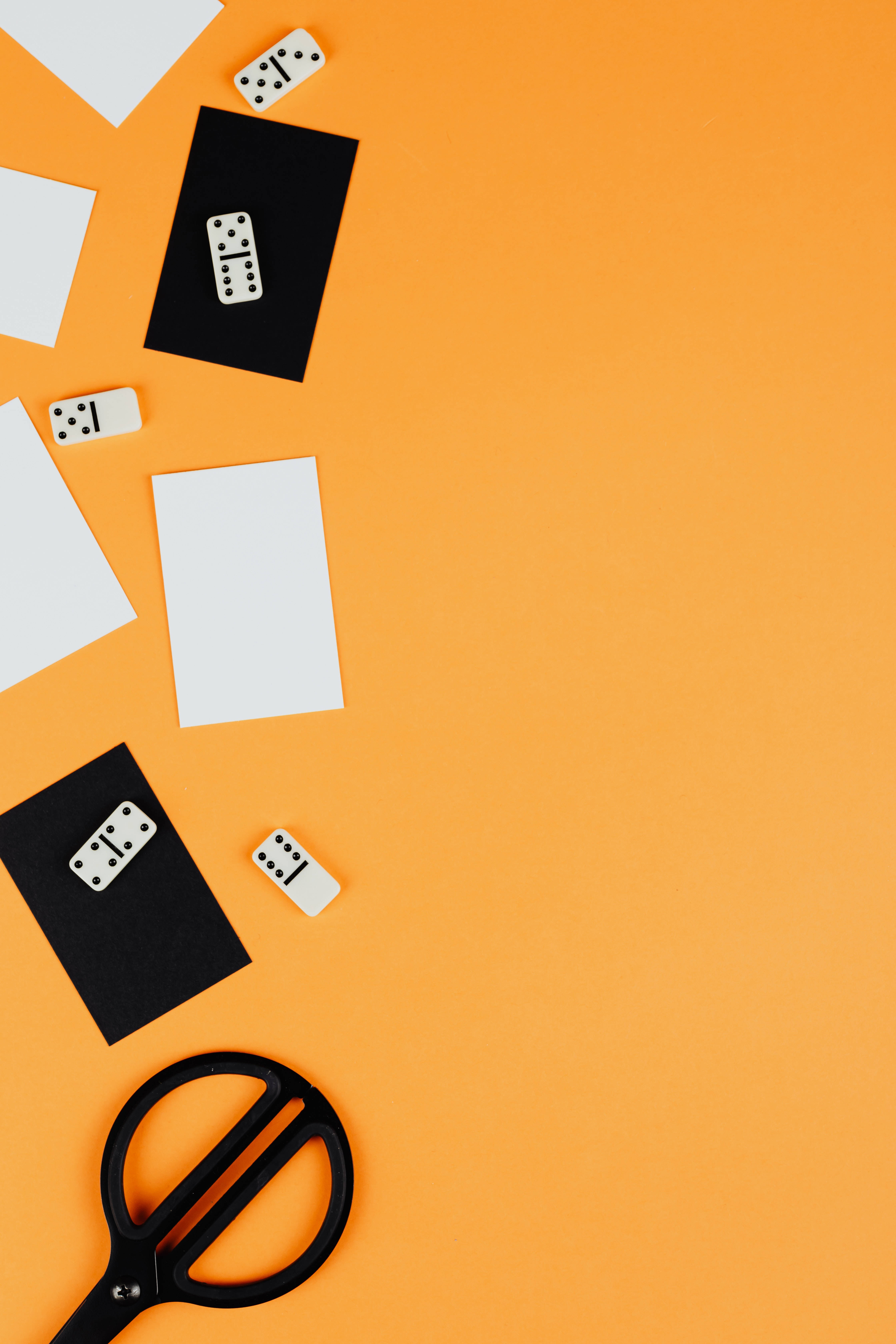 Domino, black paper cards, vibrant orange background, 5K Phone Wallpaper