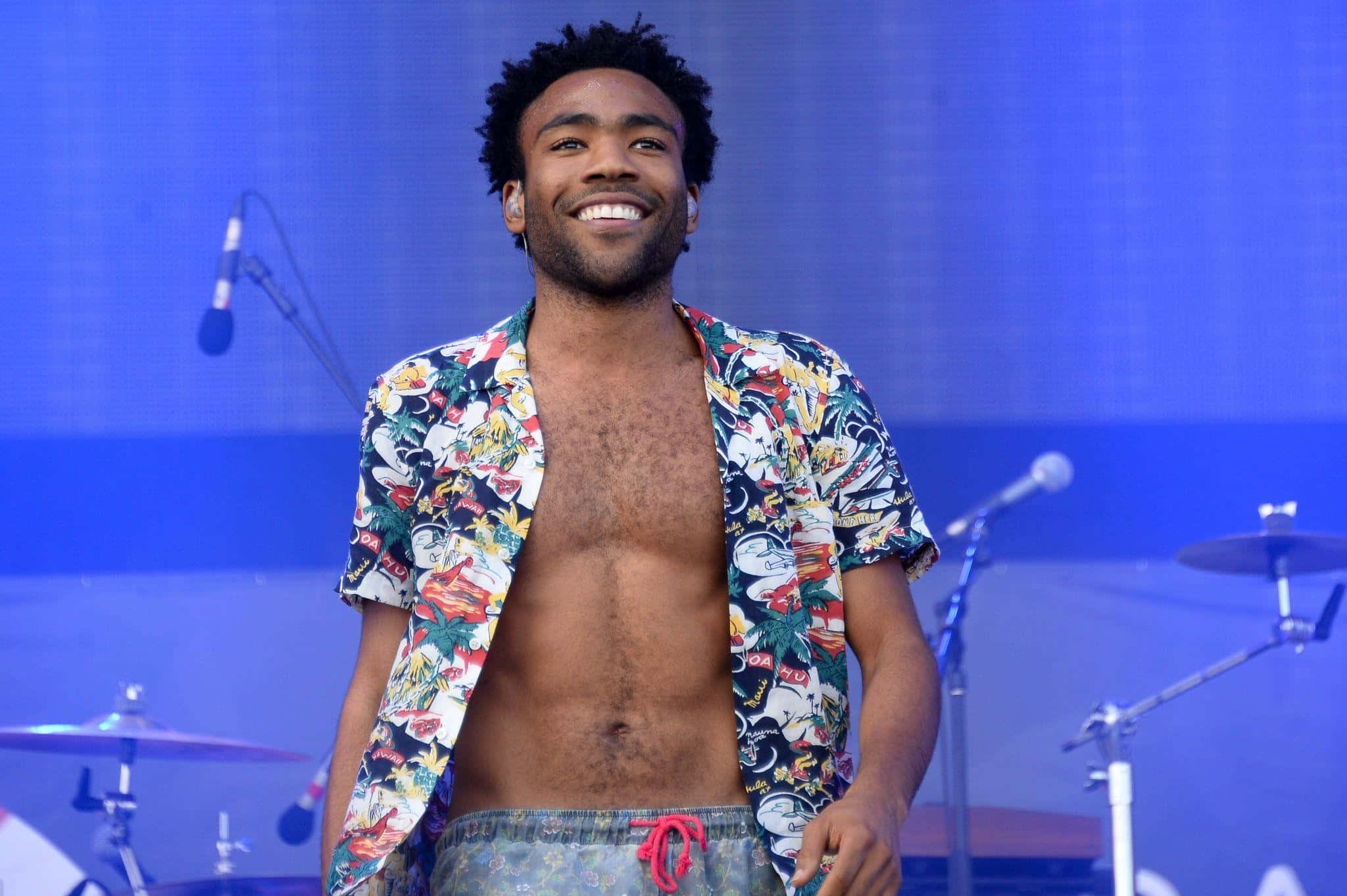 Donald Glover, blue-lit stage, microphones, Full HD Desktop Wallpaper