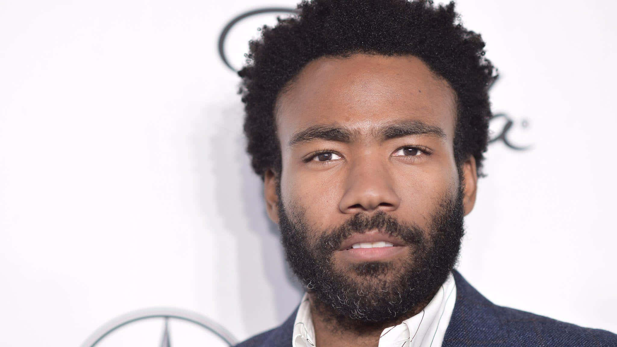 Donald Glover, dark suit, white branded backdrop, Full HD Desktop Wallpaper