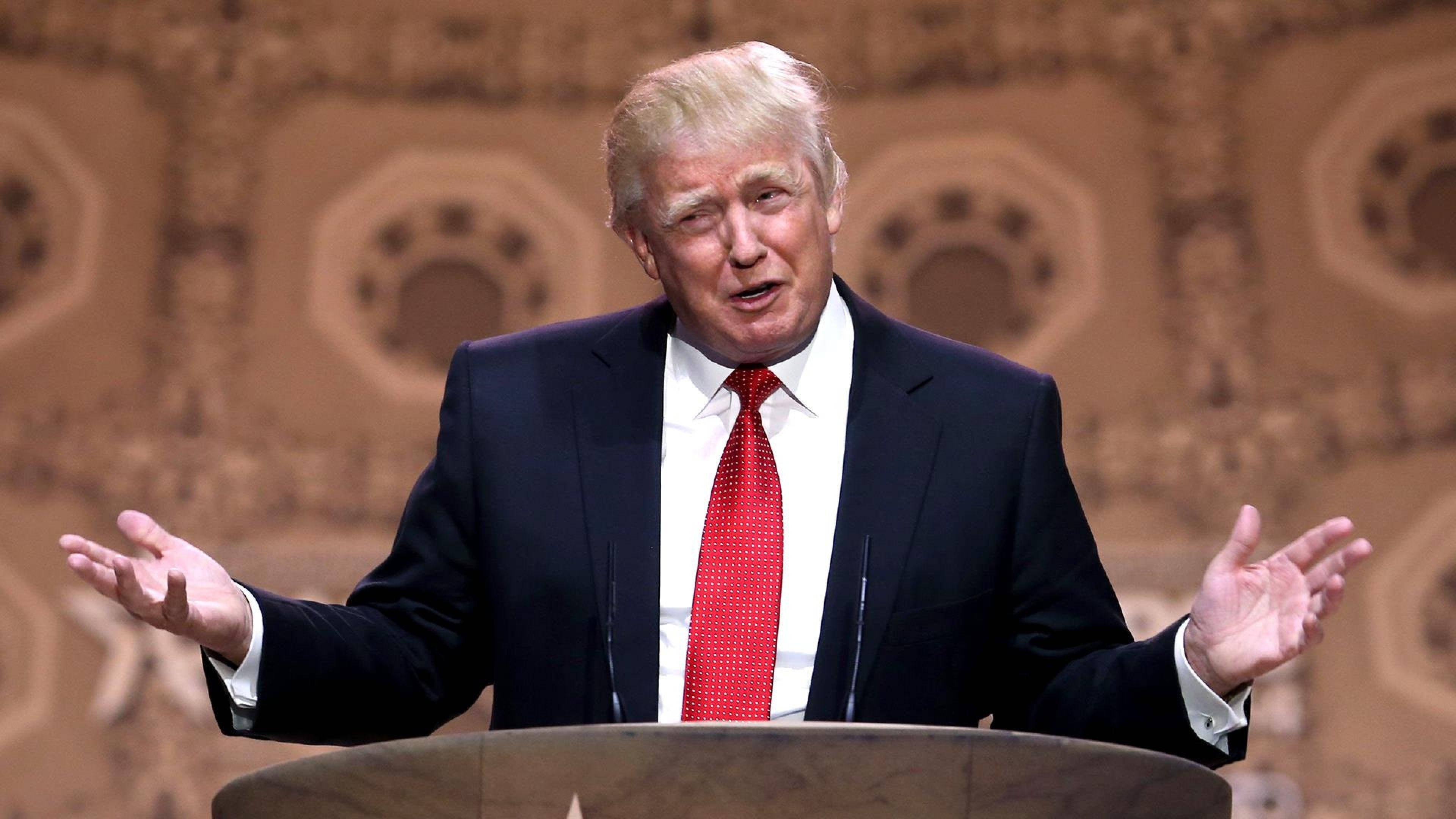 Donald Trump, podium, ornate patterned backdrop, 4K Desktop Wallpaper