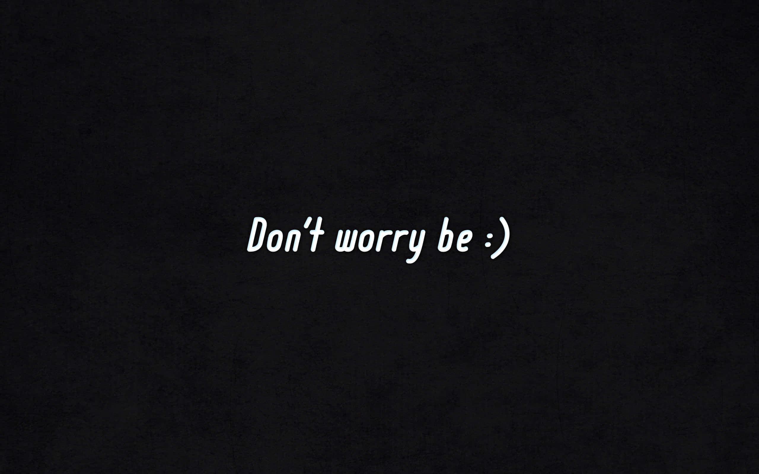 Don't worry be happy, white cursive text, dark background, 2K Desktop Wallpaper