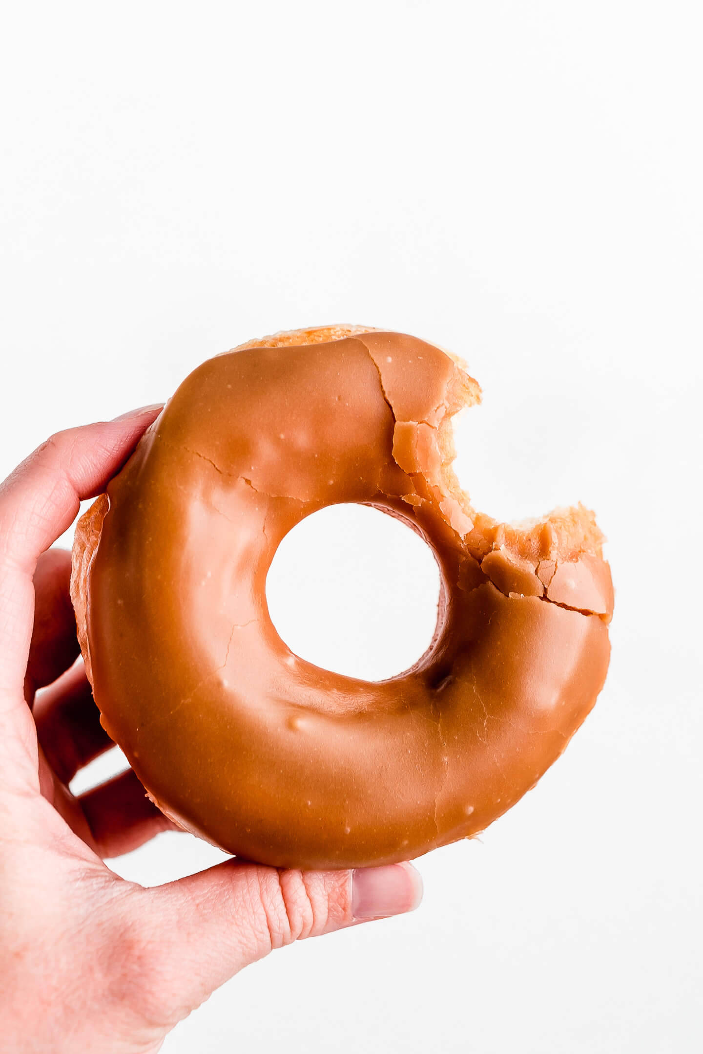caramel glazed donut, partially eaten, hand, Full HD Phone Wallpaper