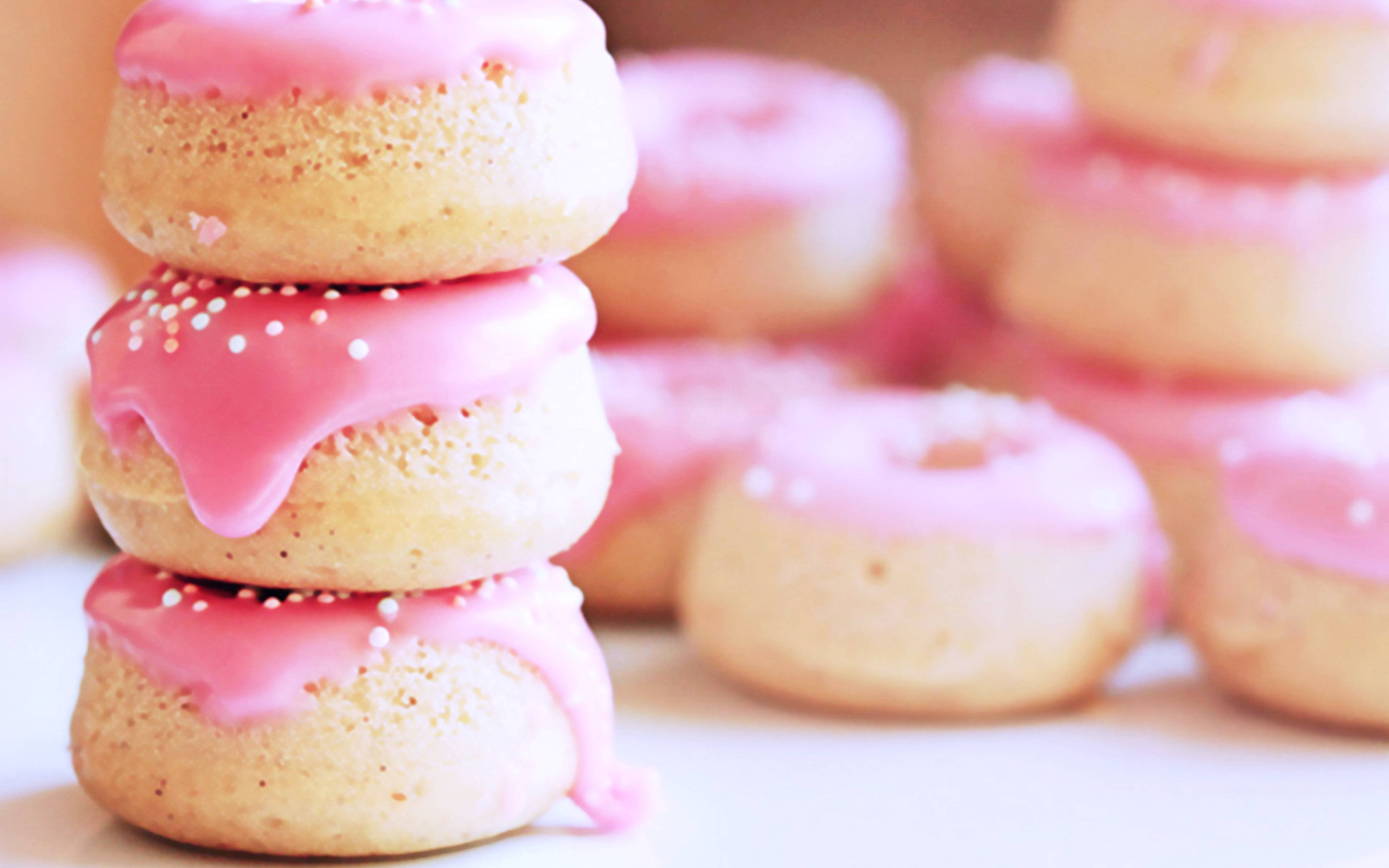 stacked pink mini donuts, pink-frosted donuts, white sprinkles, 4K Desktop Wallpaper