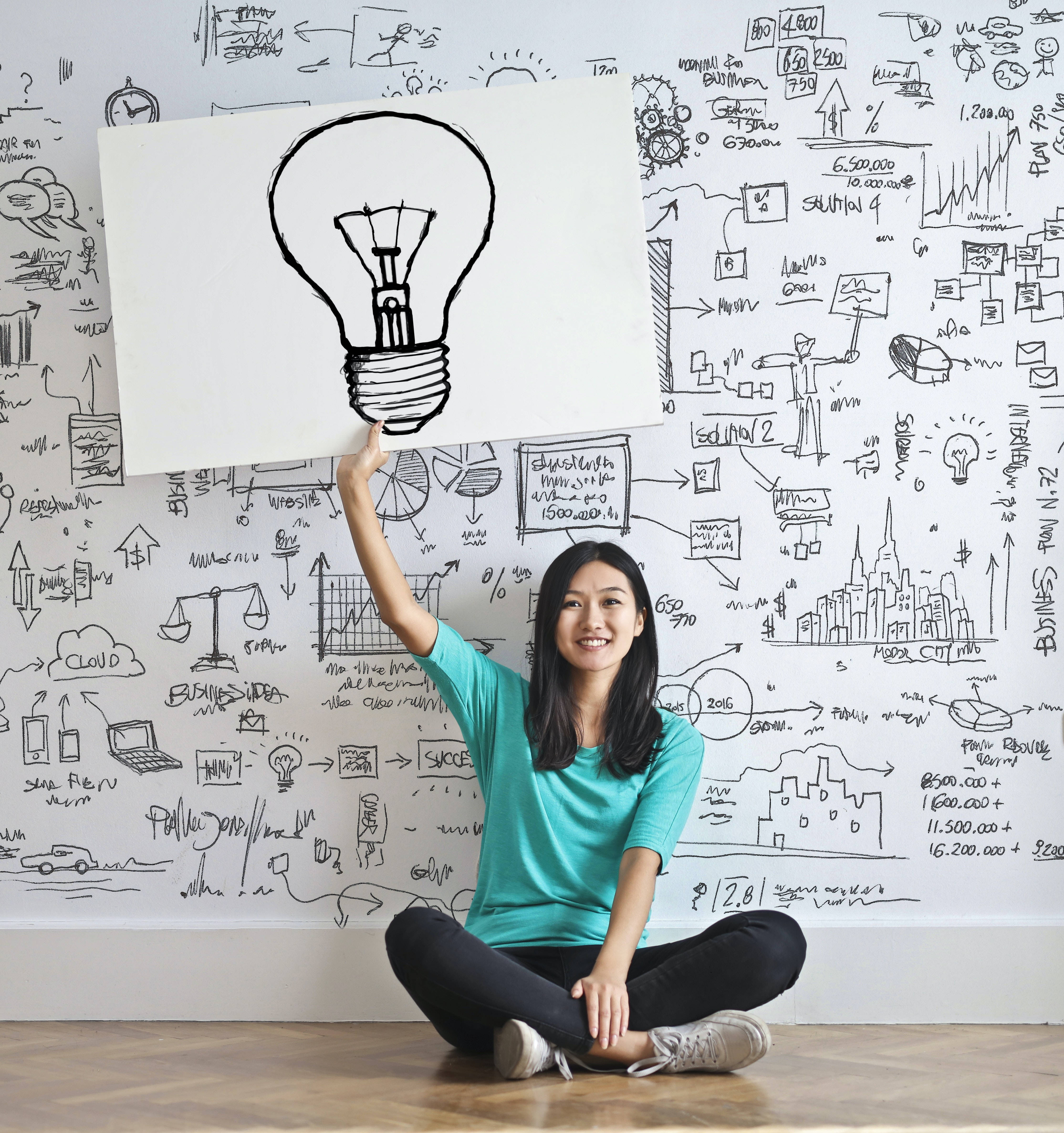 lightbulb sketch, wall covered in business doodles and diagrams, smiling woman, 4K Phone Wallpaper