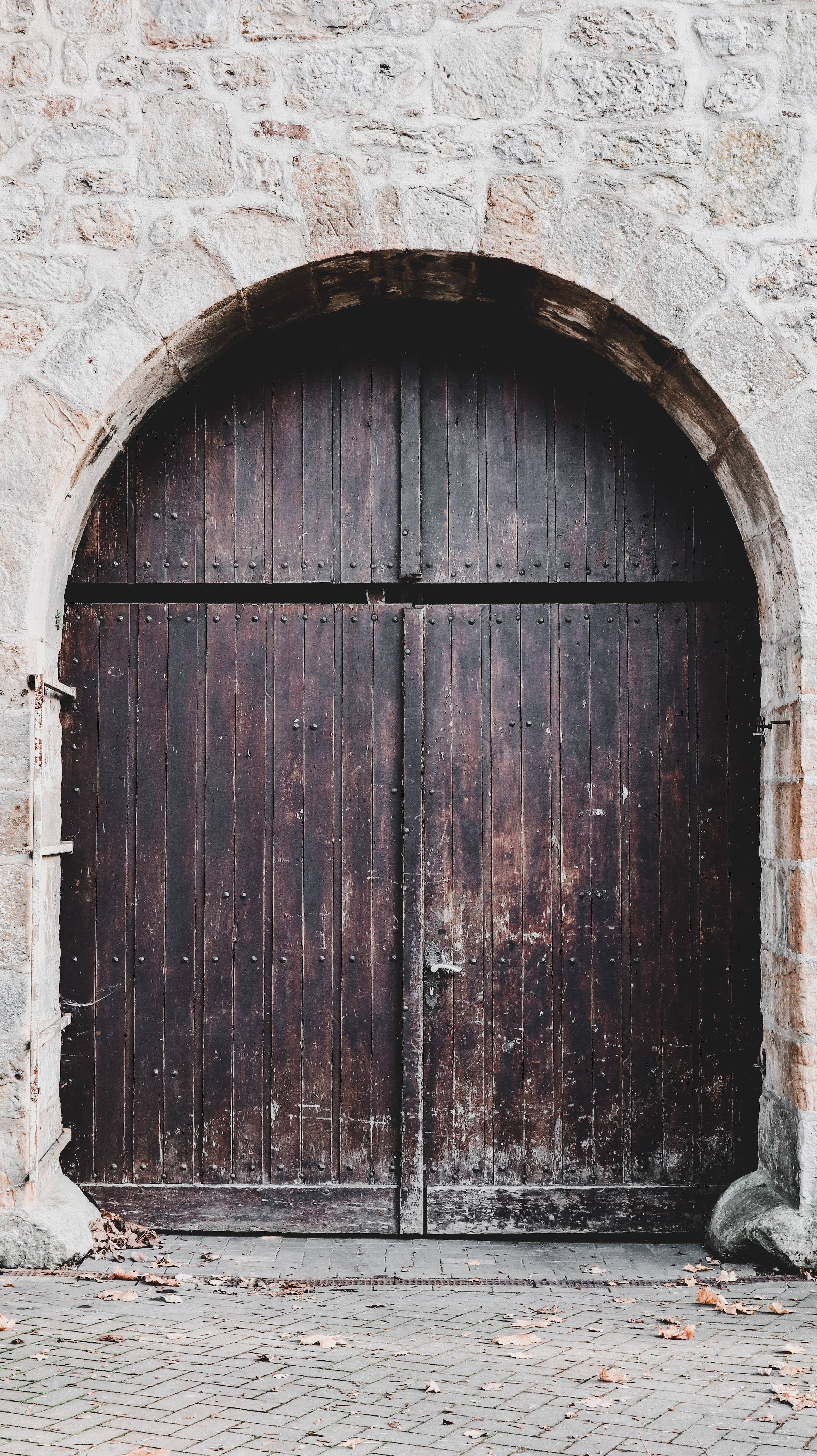 wooden door, faded black paint, stone archway, 4K Phone Wallpaper