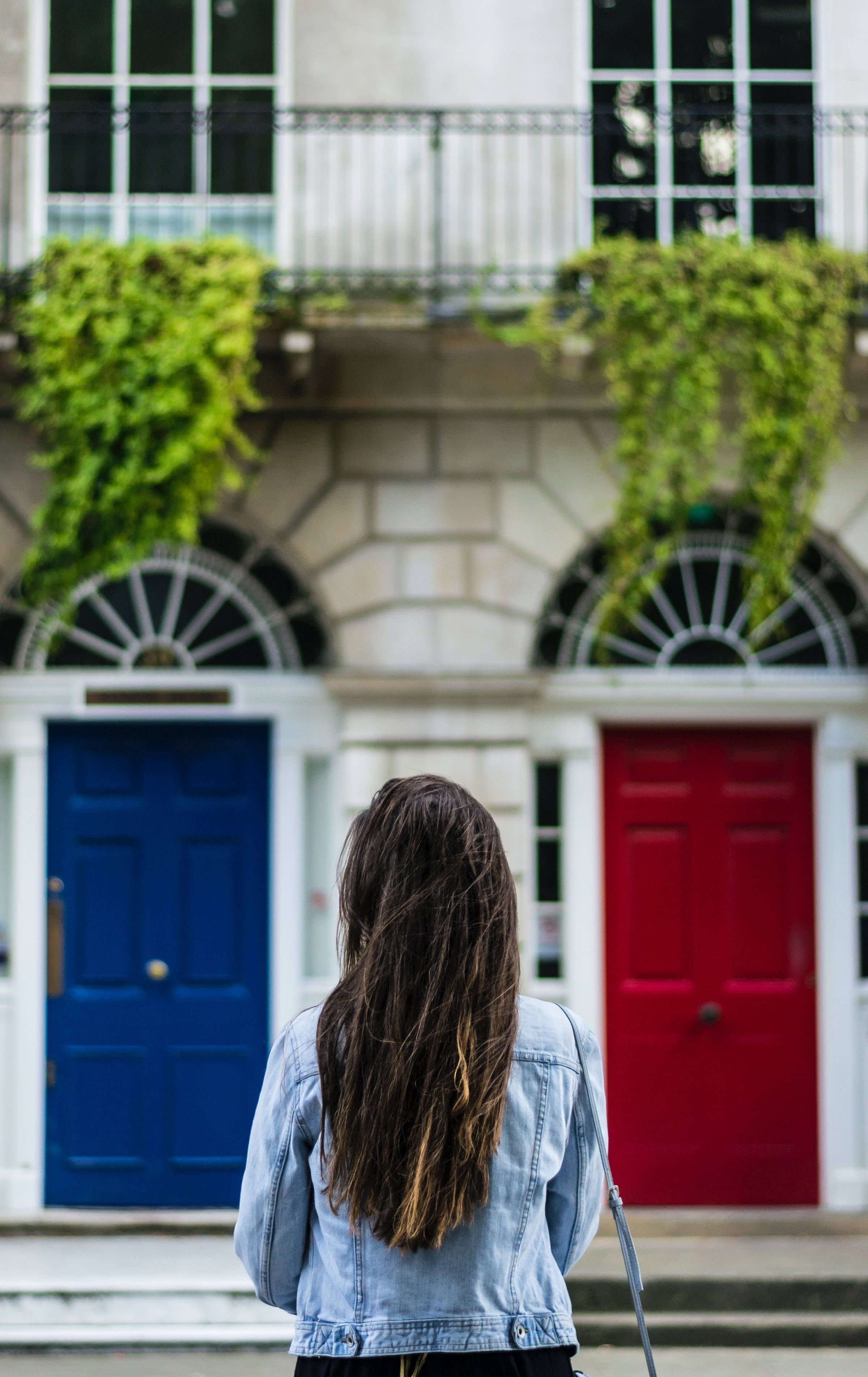 long dark hair, denim jacket, colorful doors blue and red, 2K Phone Wallpaper