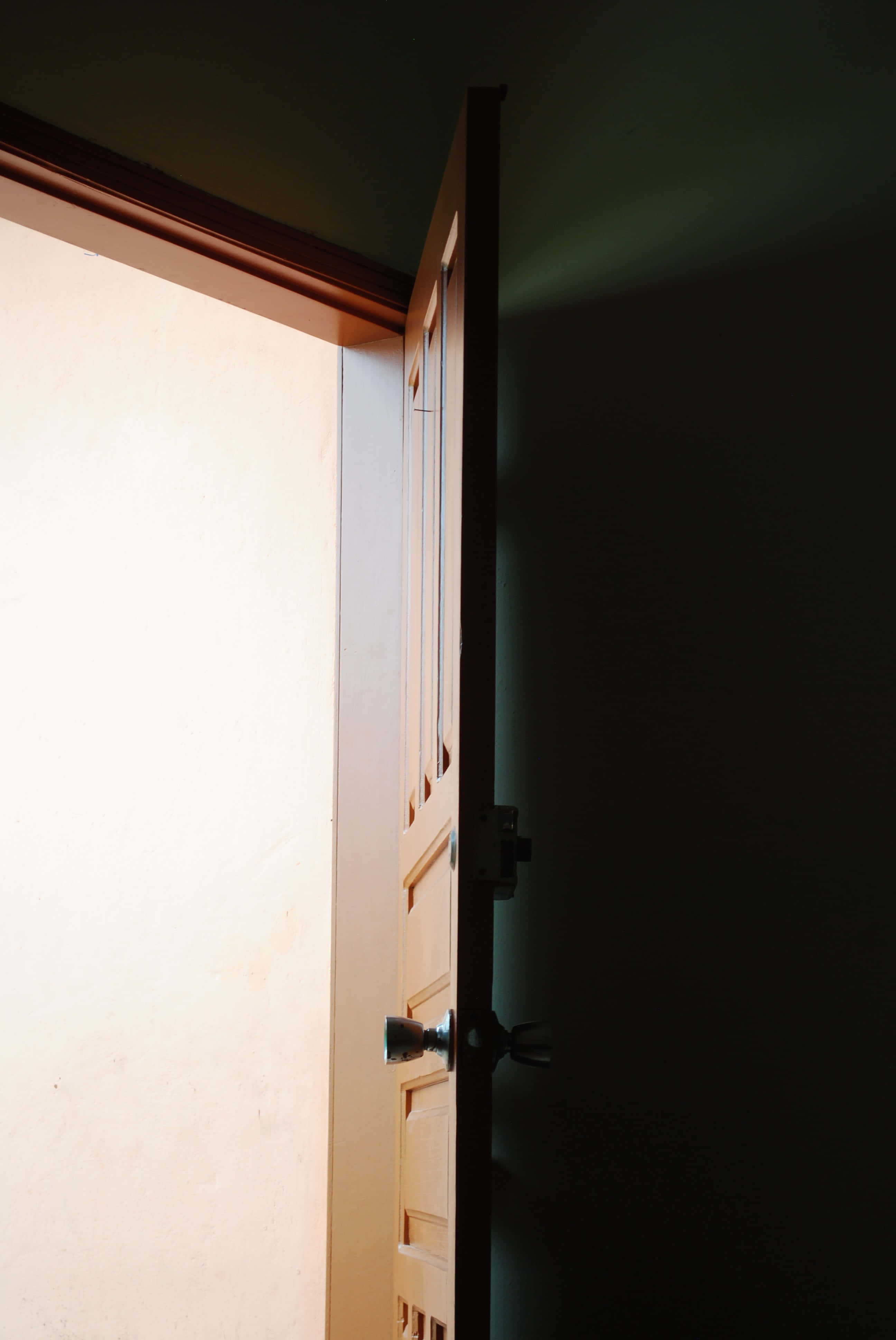 open door to darkness, wooden door, bright light, 4K Phone Wallpaper