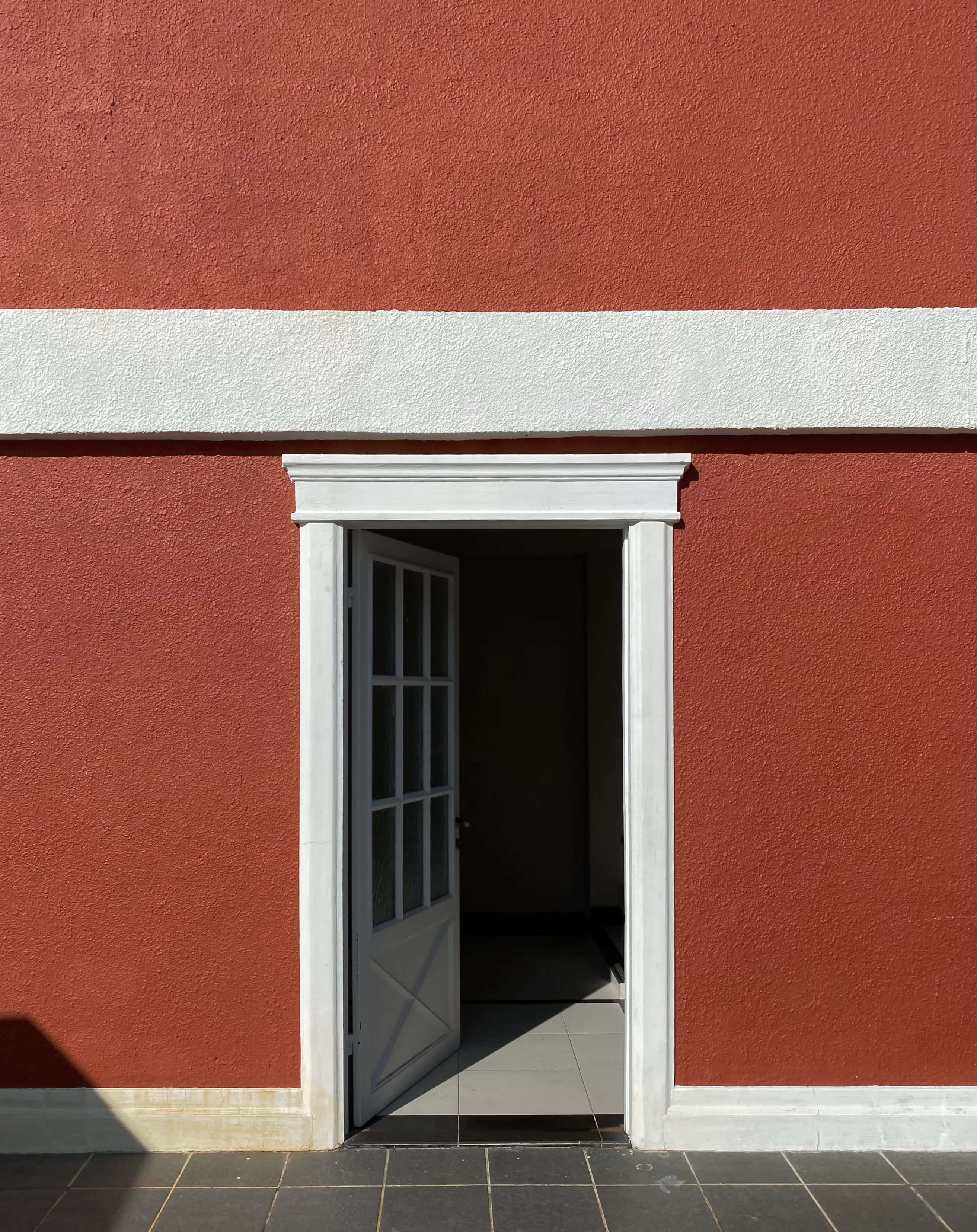 white-framed door, glass panes, textured red wall, 2K Phone Wallpaper