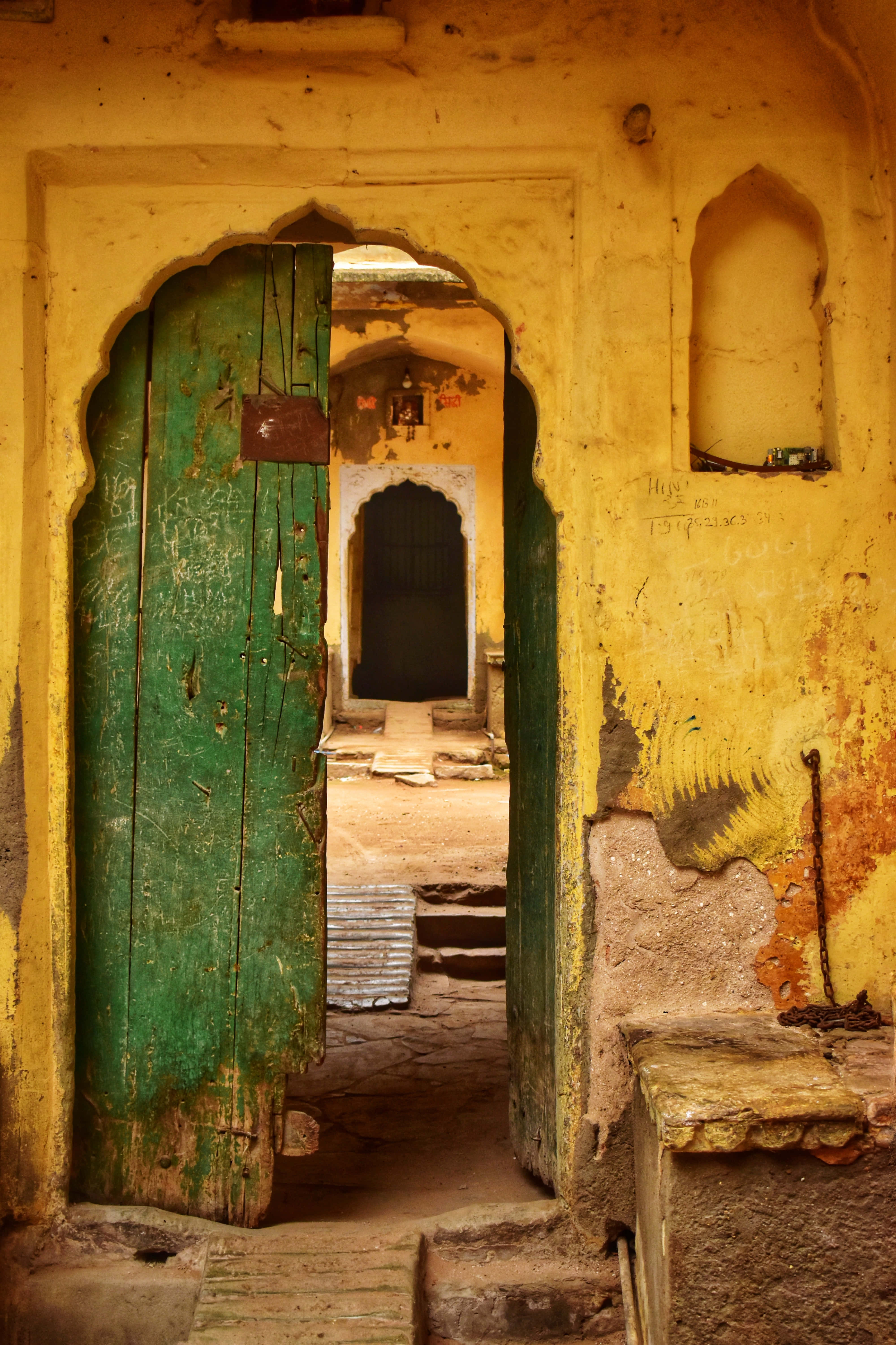 old green open door, weathered green wooden door, vibrant yellow crumbling wall, 5K Phone Wallpaper