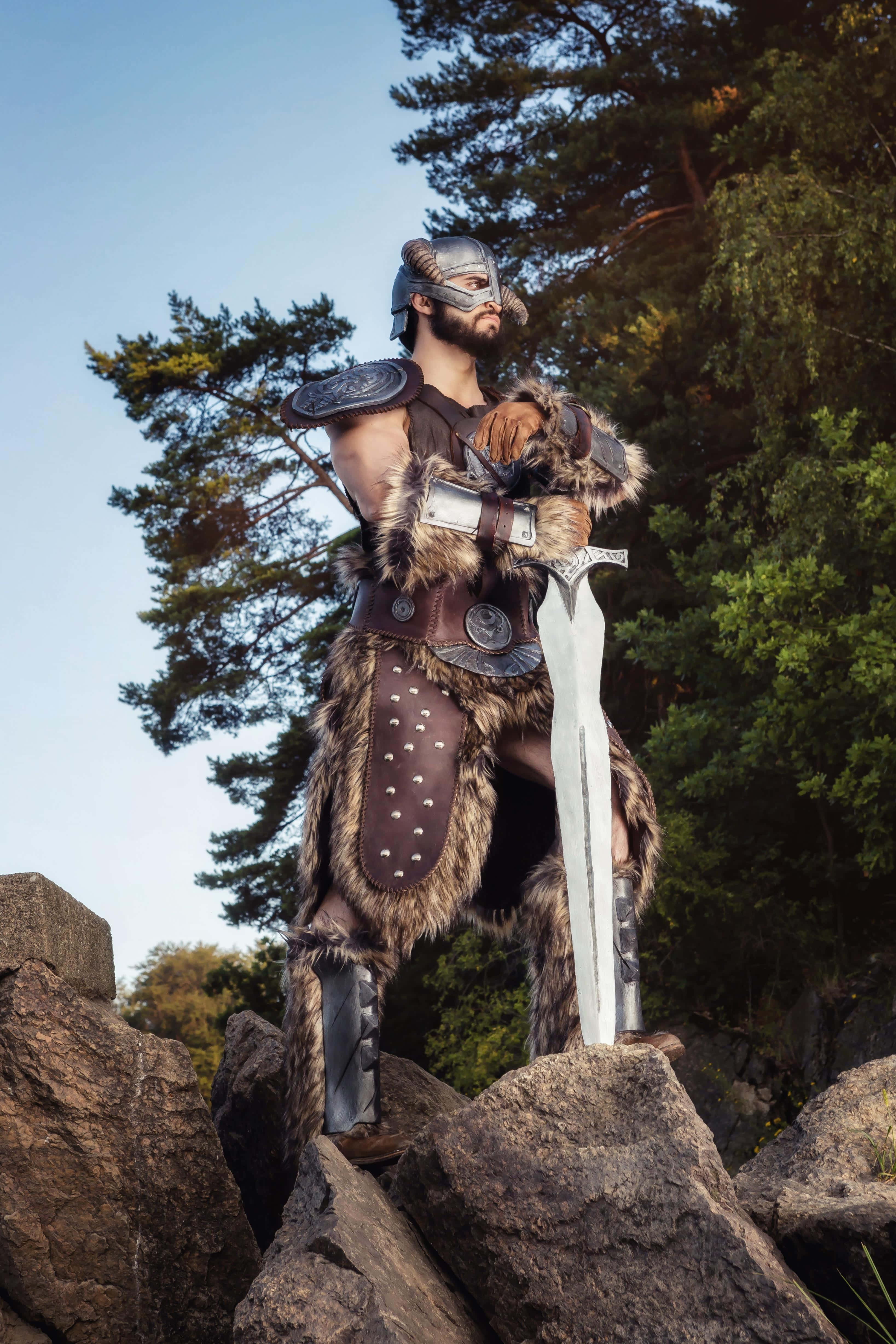 Dovahkiin, full battle gear, rocky terrain, 4K Phone Wallpaper