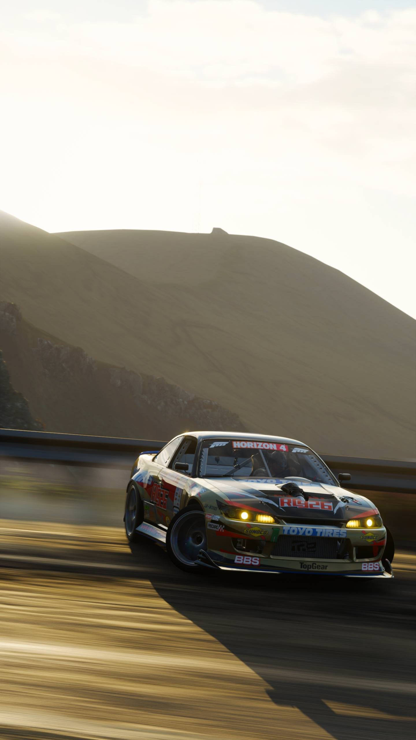 sleek race car, winding mountain road, sunset, Full HD Phone Wallpaper
