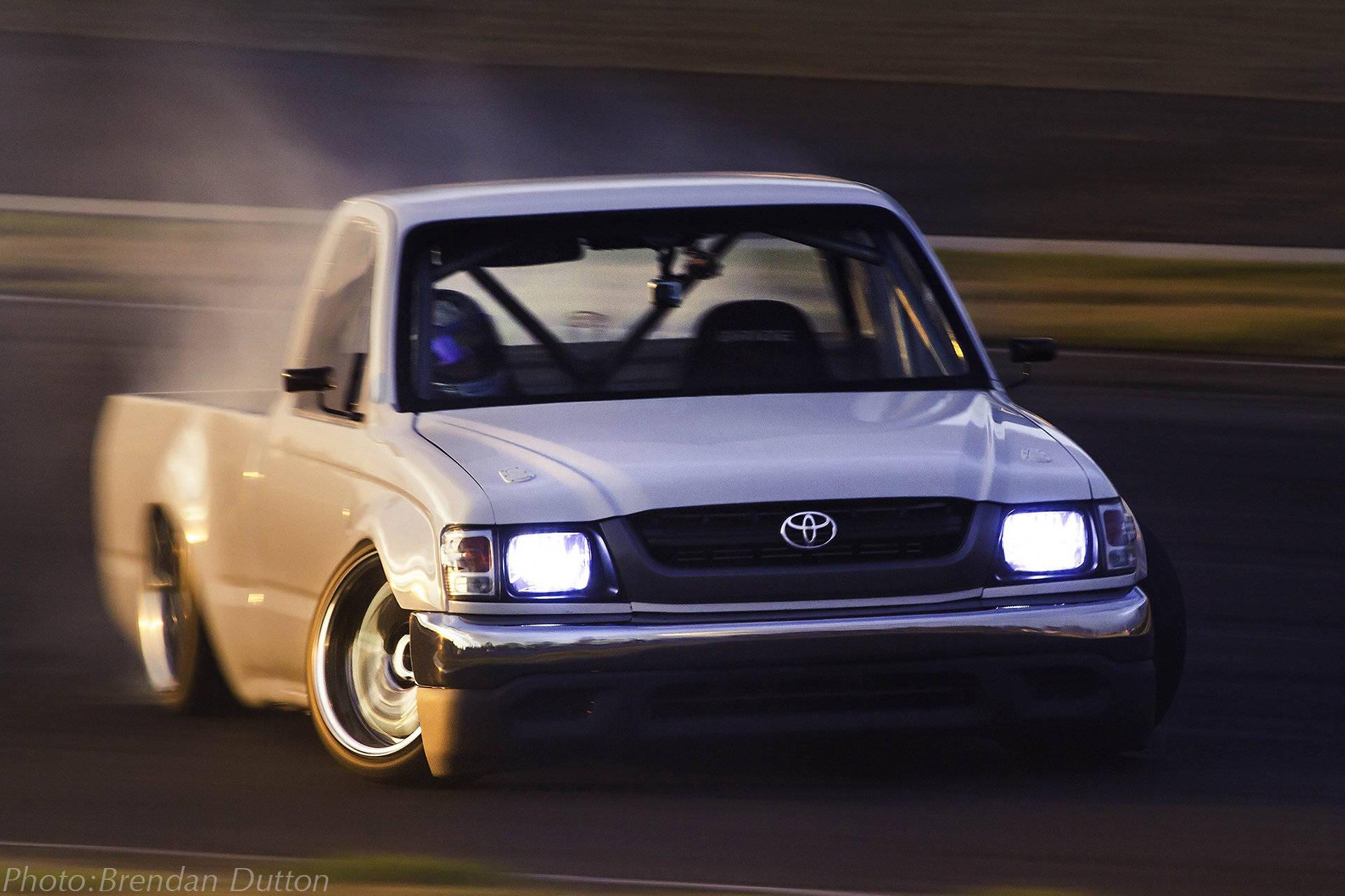 white Toyota pickup truck, glowing headlights, blurred racetrack, Full HD Desktop Wallpaper