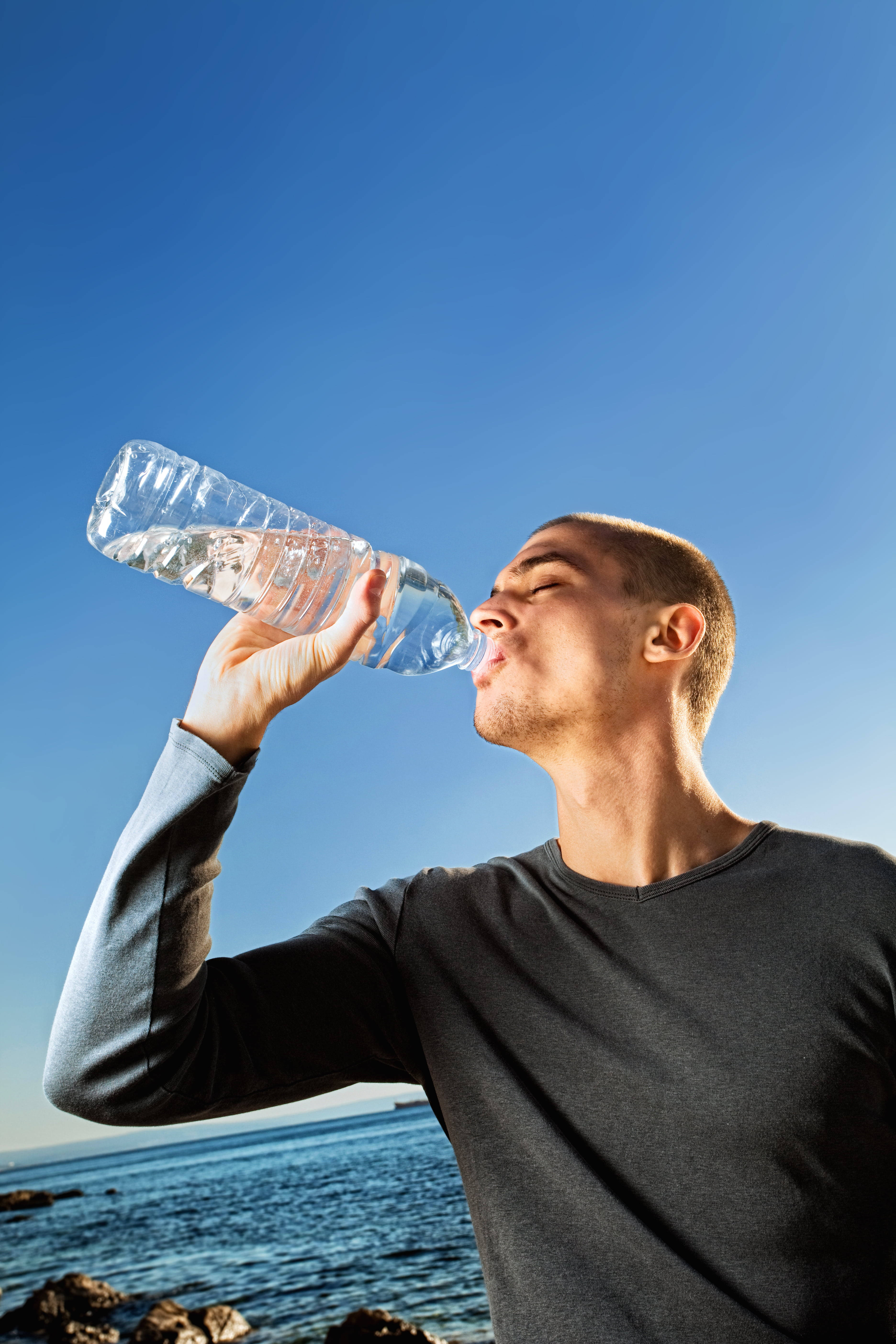 man, plastic bottle, clear blue sky, 5K Phone Wallpaper
