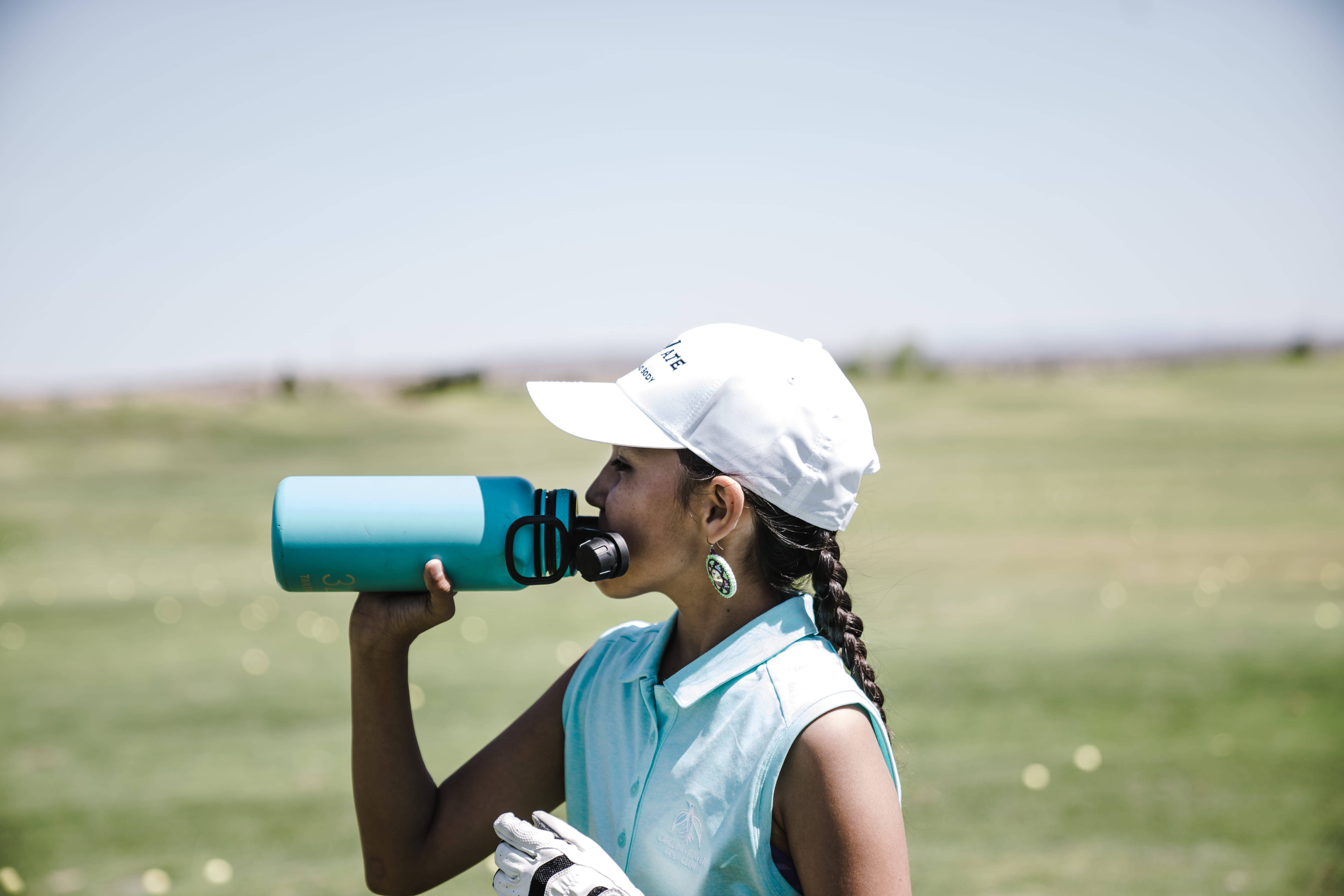 teal water bottle, sunlit golf course, blurred green fairways, 8K Desktop Wallpaper