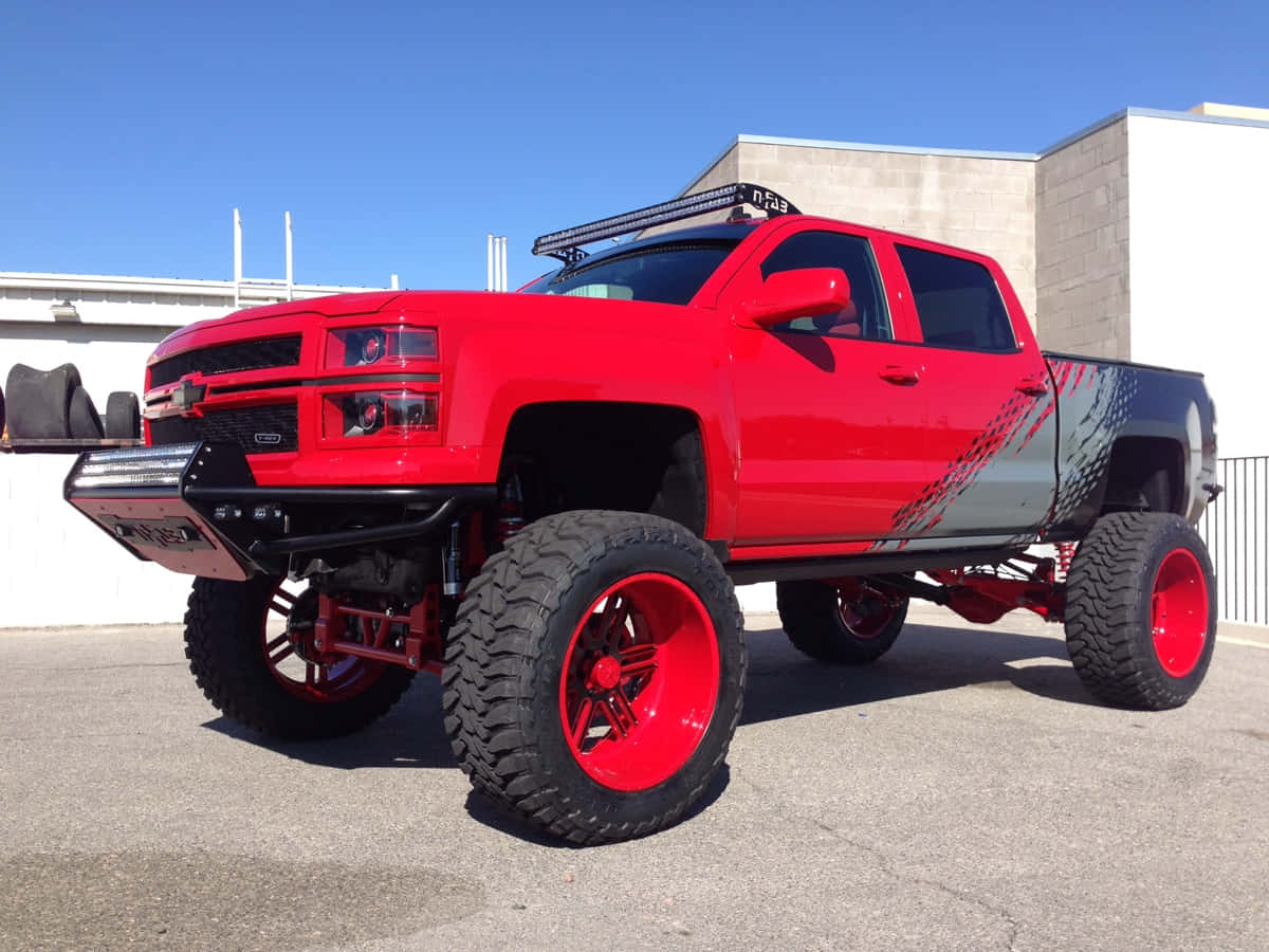 Chevrolet pickup truck, vibrant red paint, oversized tires, SD Desktop Wallpaper