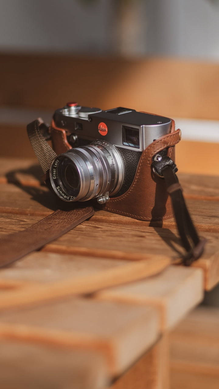 vintage silver camera, leather strap, warm wooden surface, HD Phone Wallpaper