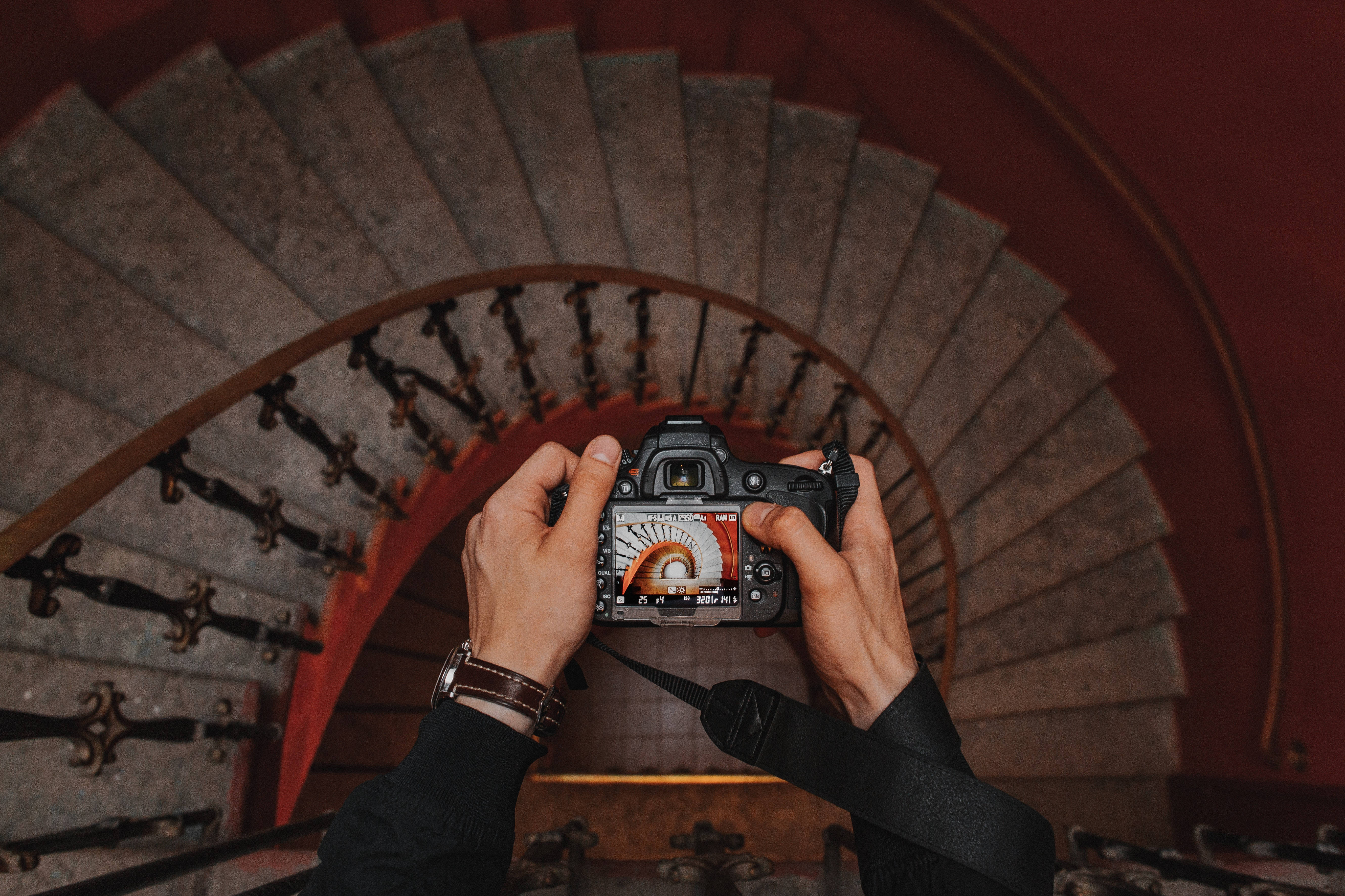 DSLR camera, spiraling stone staircase, ornate iron railings, 5K Desktop Wallpaper