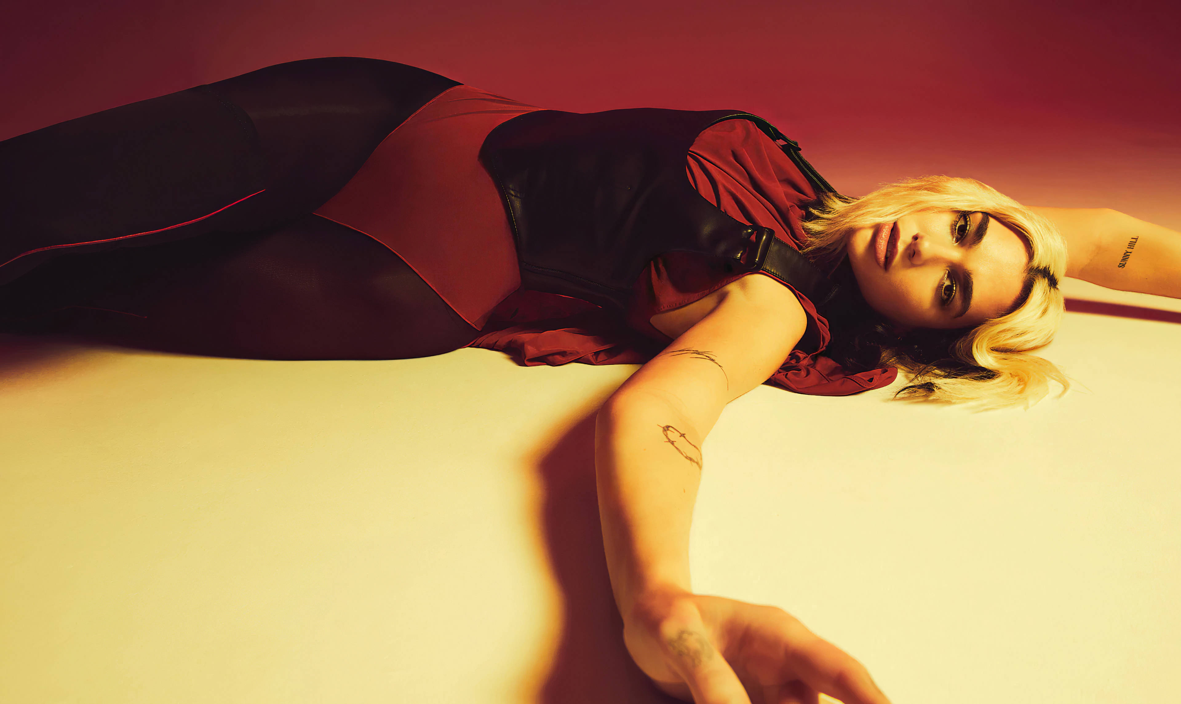 Dua Lipa, red and black bodysuit, white floor, 4K Desktop Wallpaper