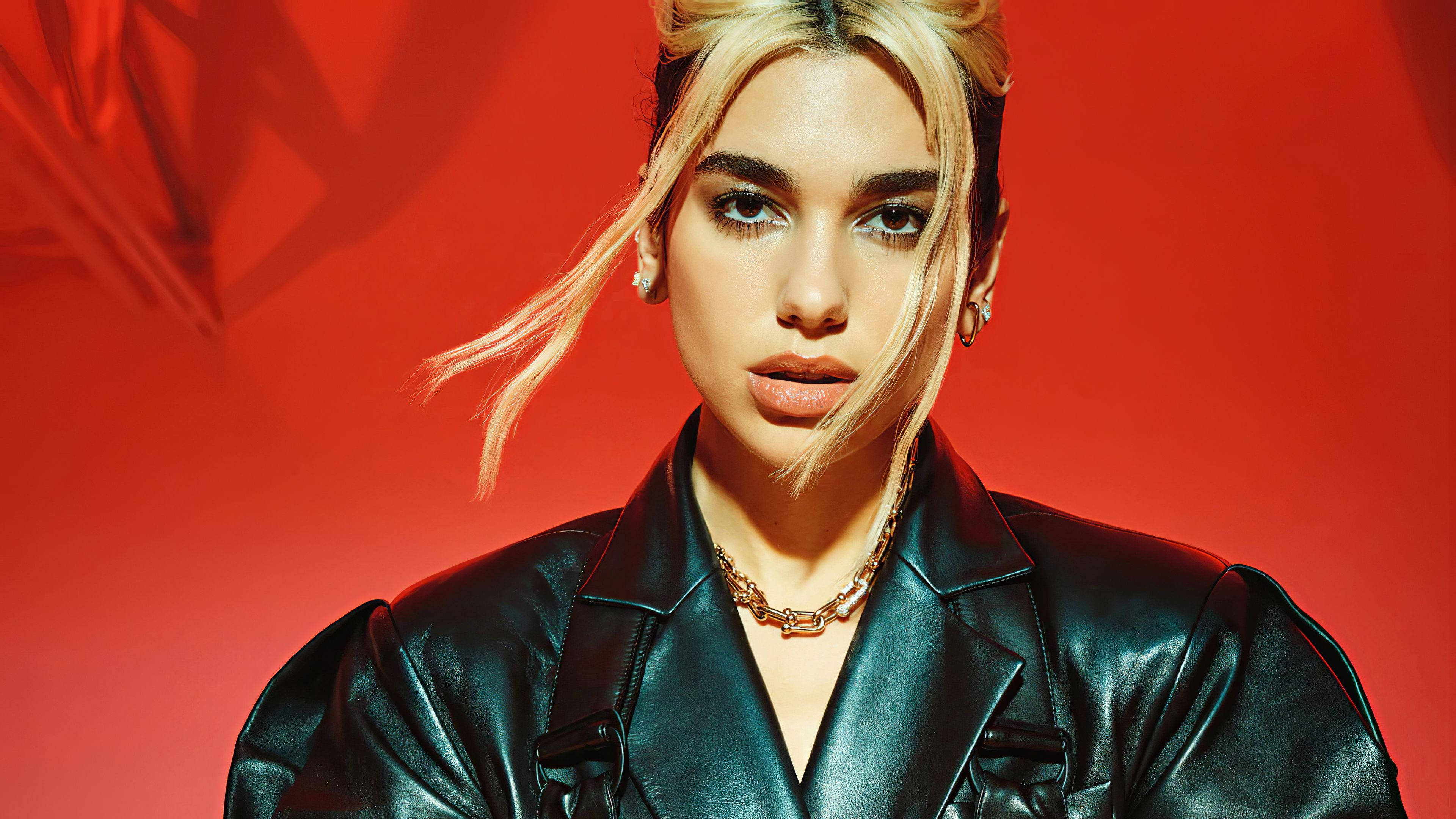Dua Lipa, black leather jacket, vivid red studio backdrop, 4K Desktop Wallpaper