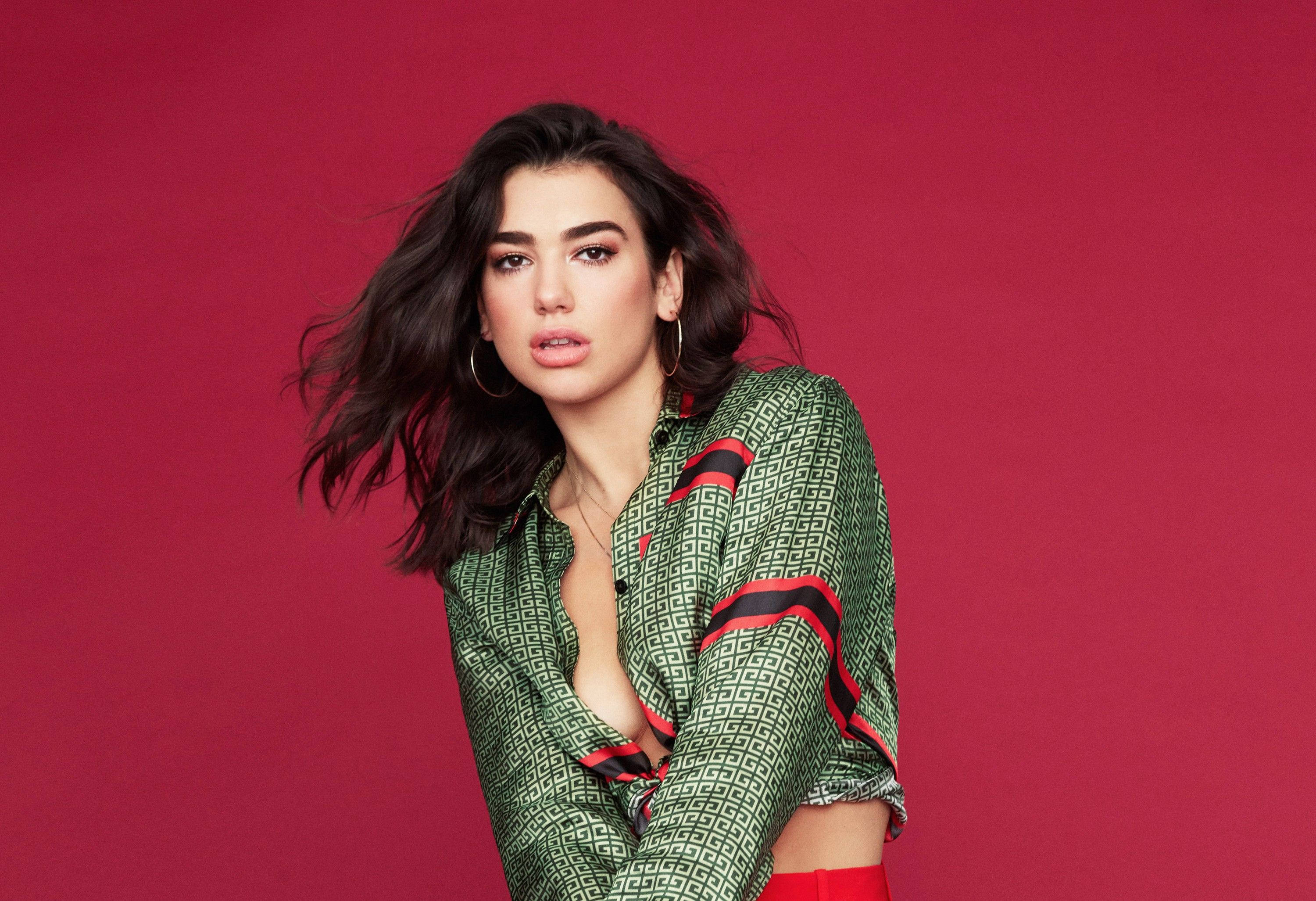 Dua Lipa, green patterned blouse, bold red background, 2K Desktop Wallpaper