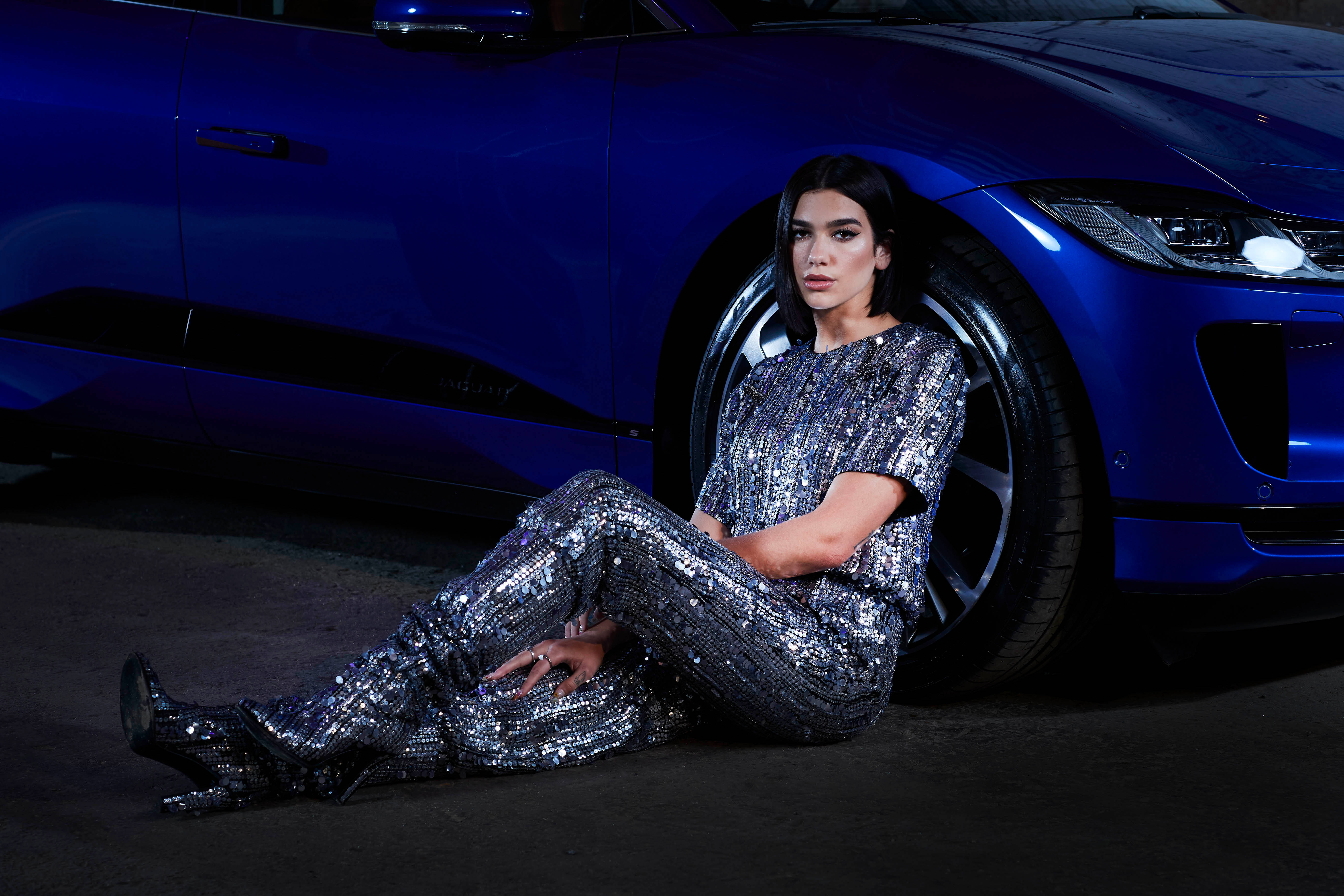 Dua Lipa, shimmering silver sequin jumpsuit, glossy blue sports car, 5K Desktop Wallpaper