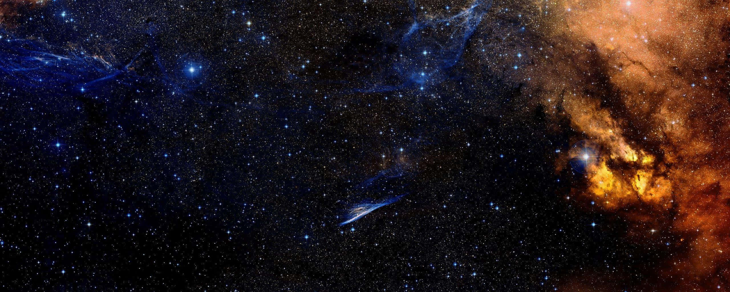 Dual Screen Space, cosmic nebula, swirling orange and blue clouds, 2K Desktop Wallpaper