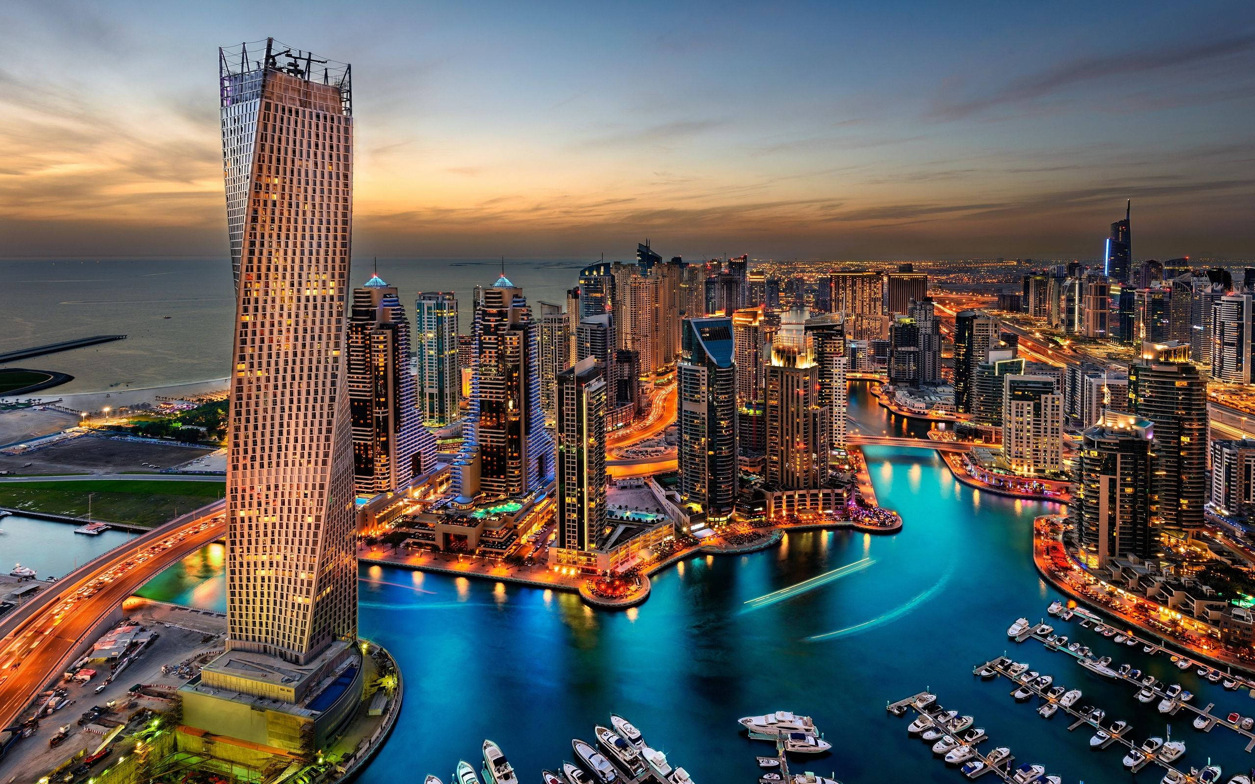 Dubai skyline, dusk, illuminated skyscrapers, 2K Desktop Wallpaper