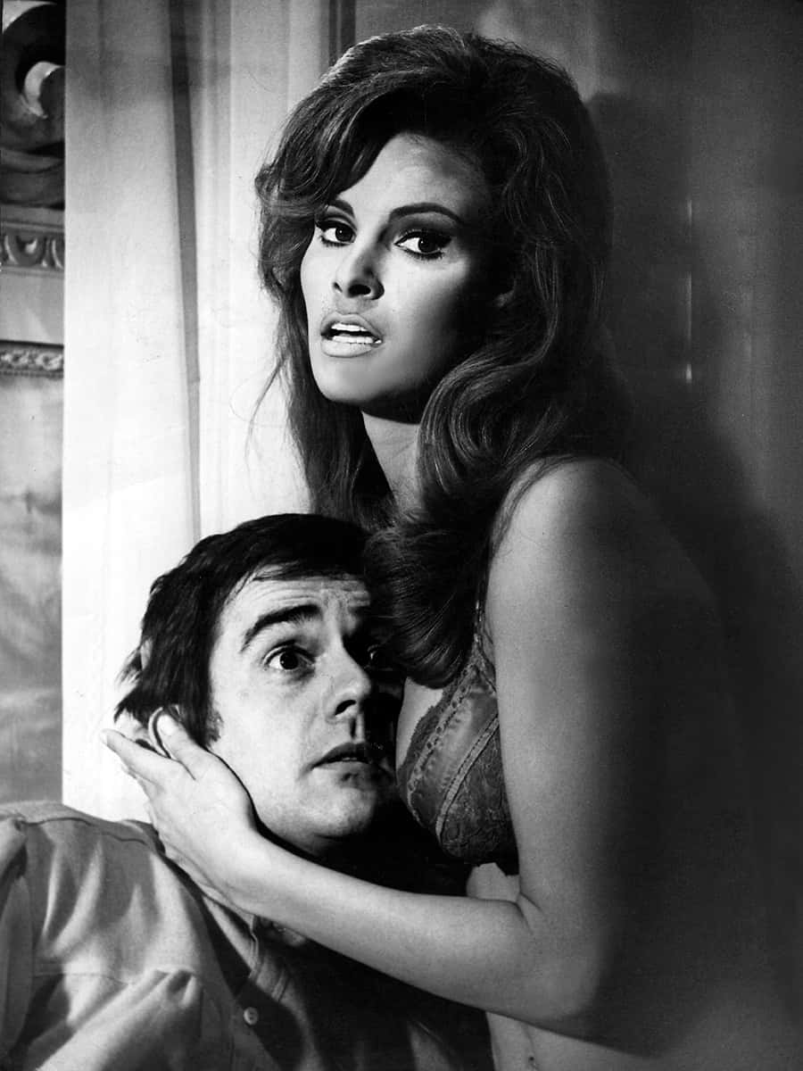 Dudley Moore, black and white photo, woman looming over a man, SD Phone Wallpaper