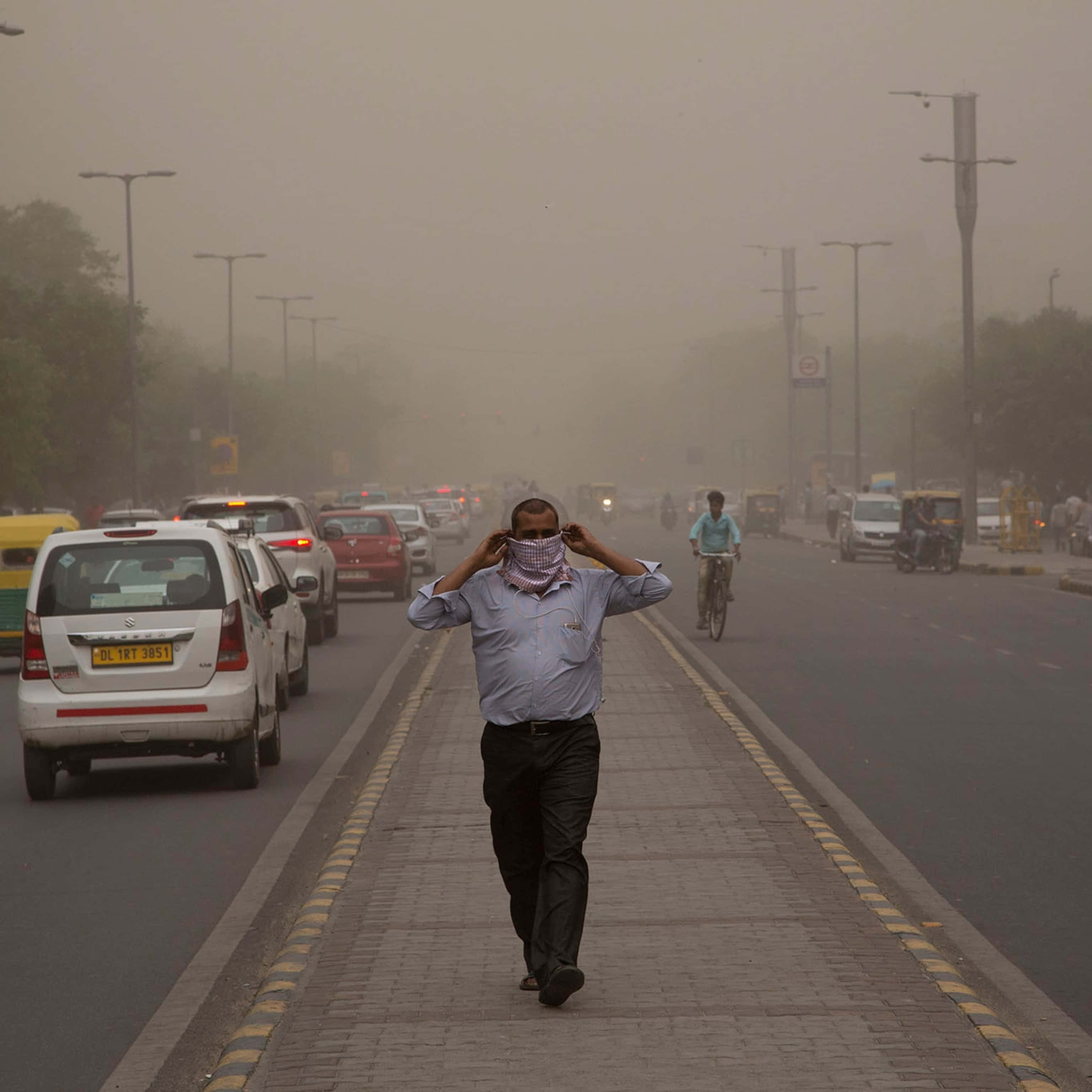 man, dust storm, smog-choked urban sidewalk, 2K Desktop Wallpaper