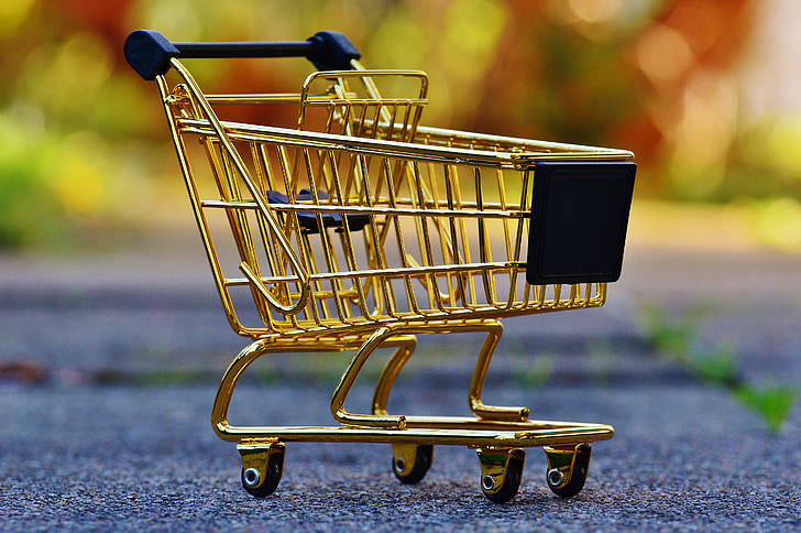 gleaming gold miniature shopping cart, asphalt, blurred autumn foliage, SD Desktop Wallpaper