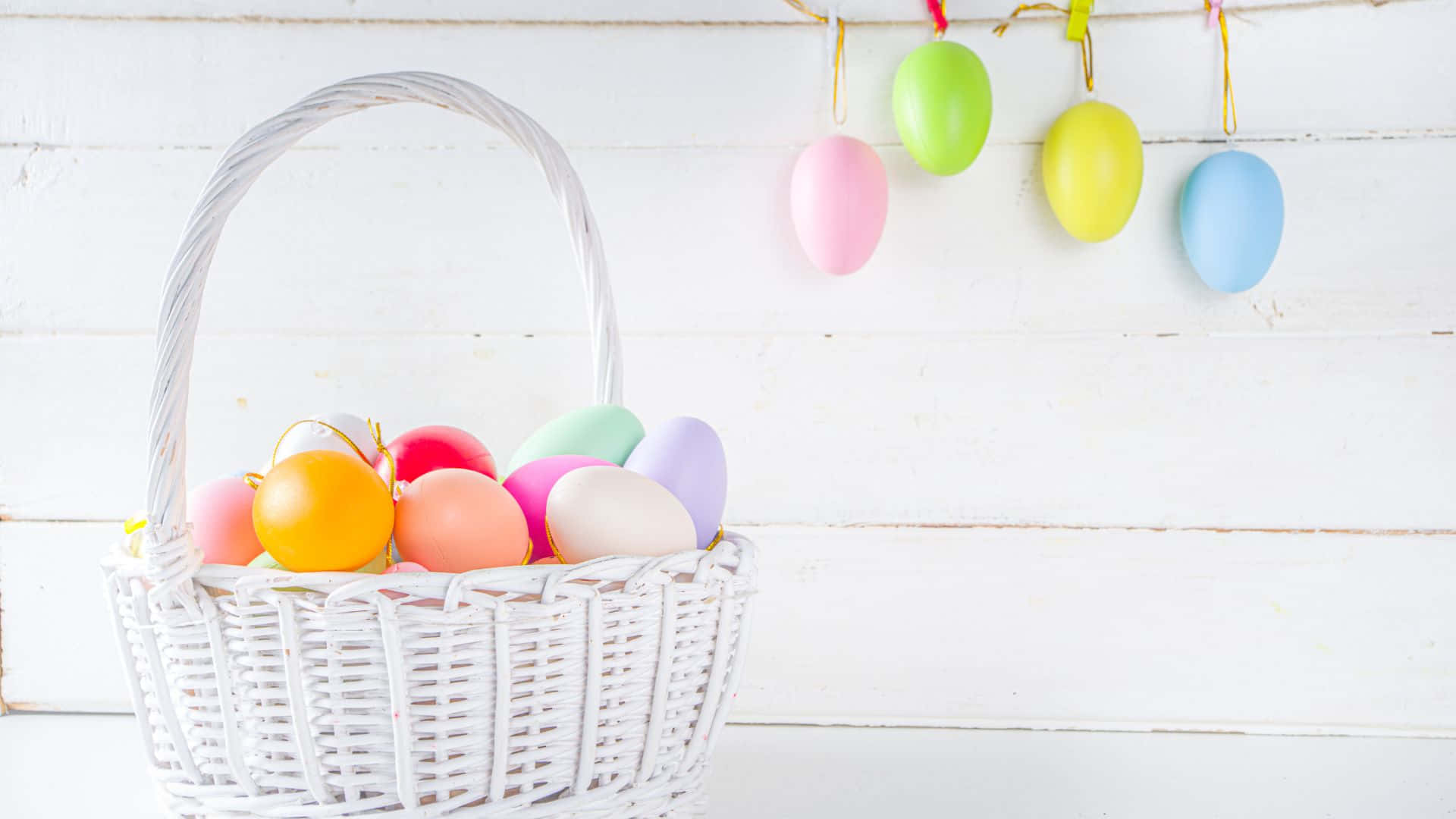 white wicker basket, colorful pastel Easter eggs, rustic white wooden wall, Full HD Desktop Wallpaper