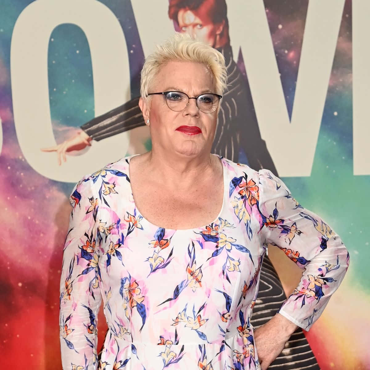 Eddie Izzard, floral dress, cosmic movie poster backdrop, SD Desktop Wallpaper