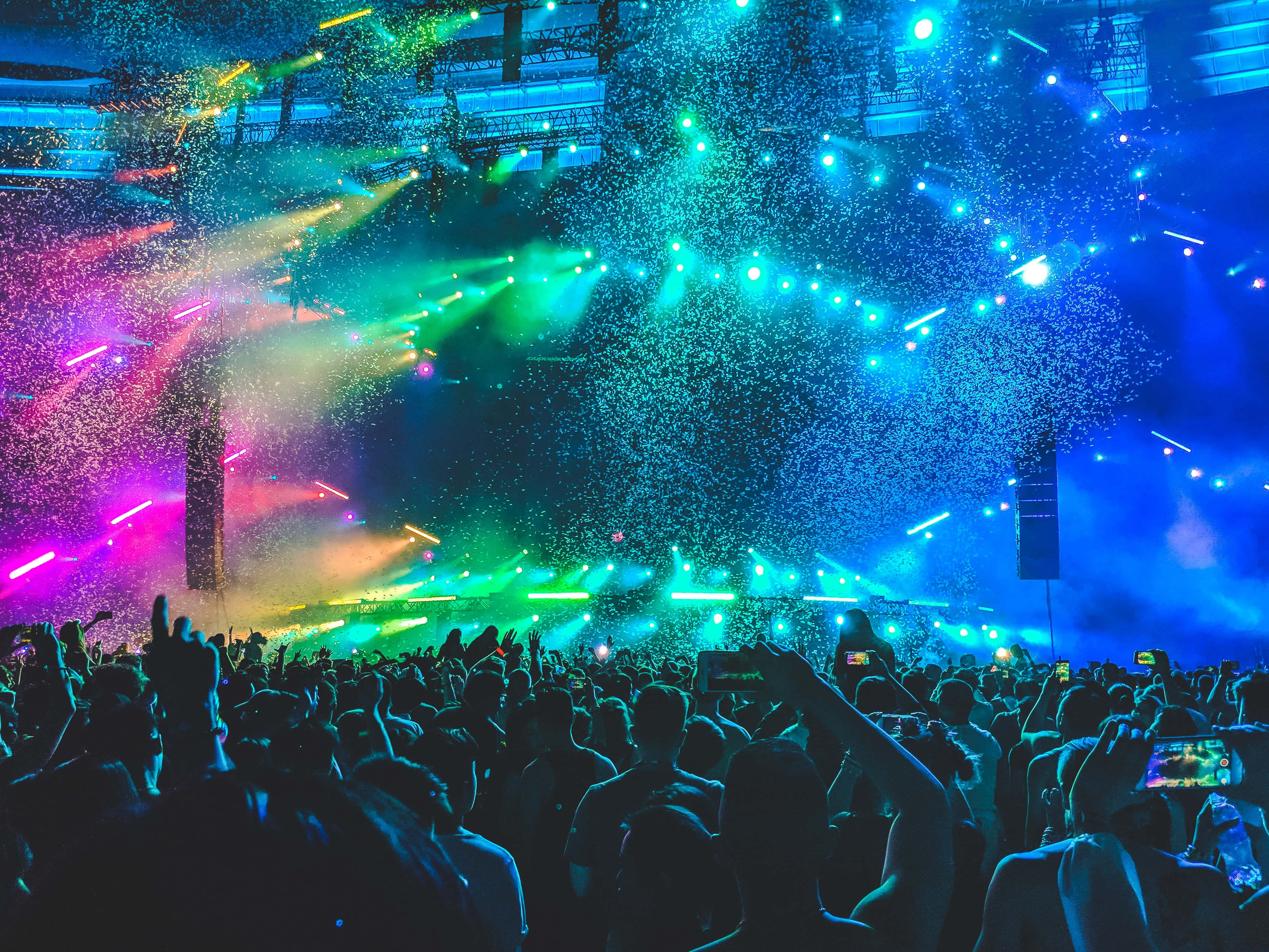 concert, vibrant blue green and pink stage lights, glittering confetti, 4K Desktop Wallpaper