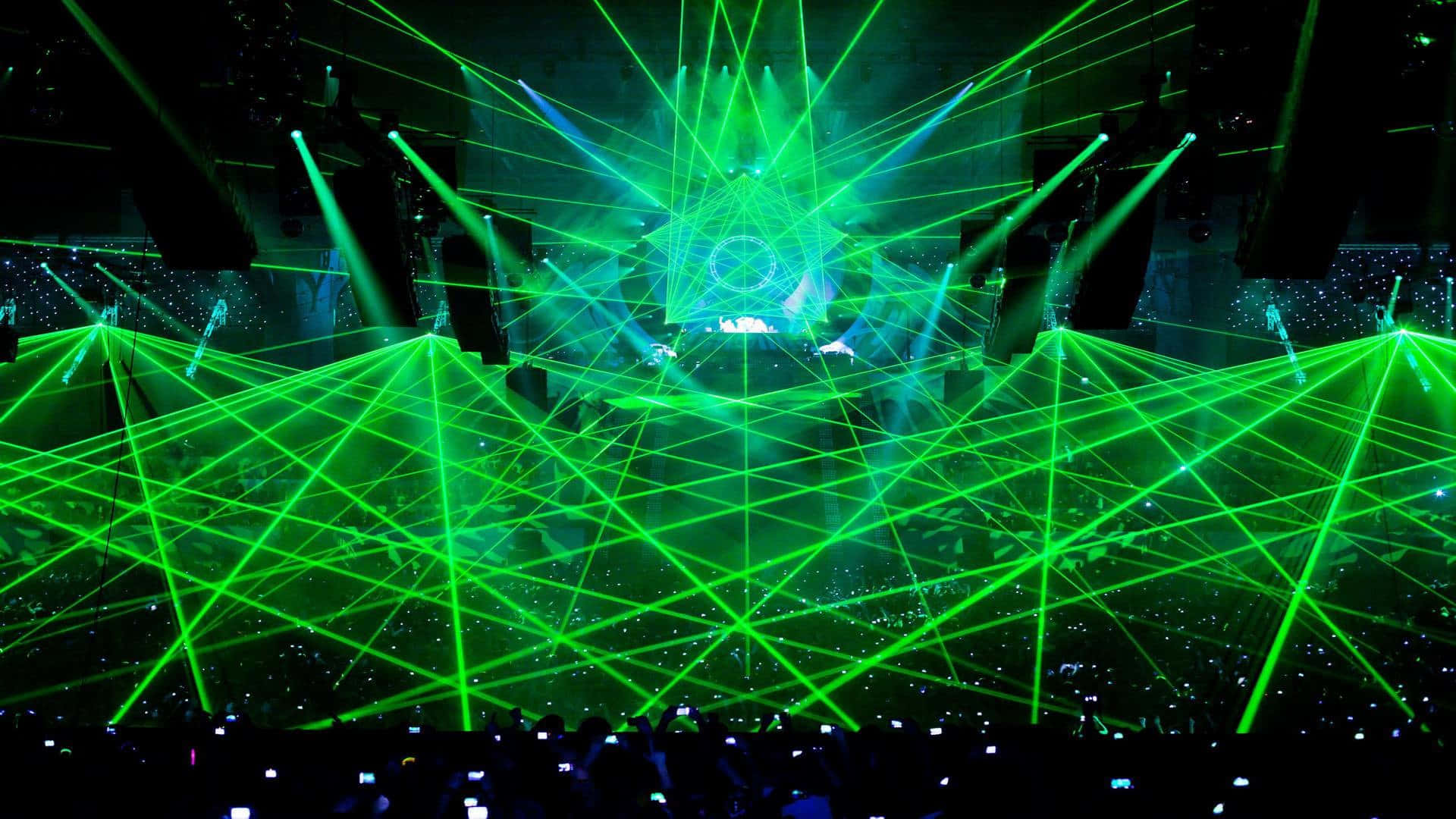 Vibrant green laser beams, dark concert stage, crowd holding up glowing phones, Full HD Desktop Wallpaper