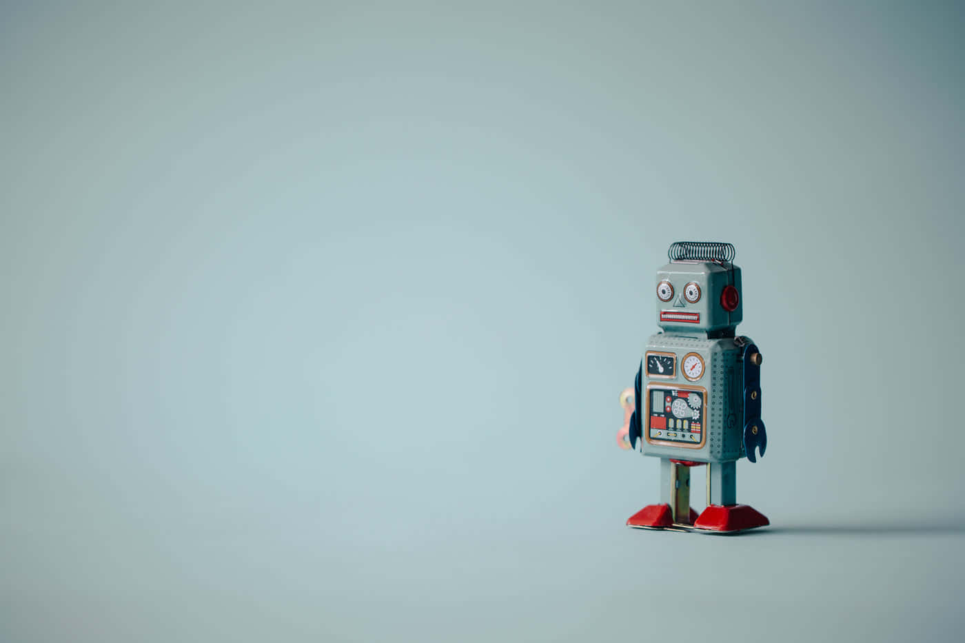 vintage tin robot toy, muted blue background, dramatic lighting, HD Desktop Wallpaper