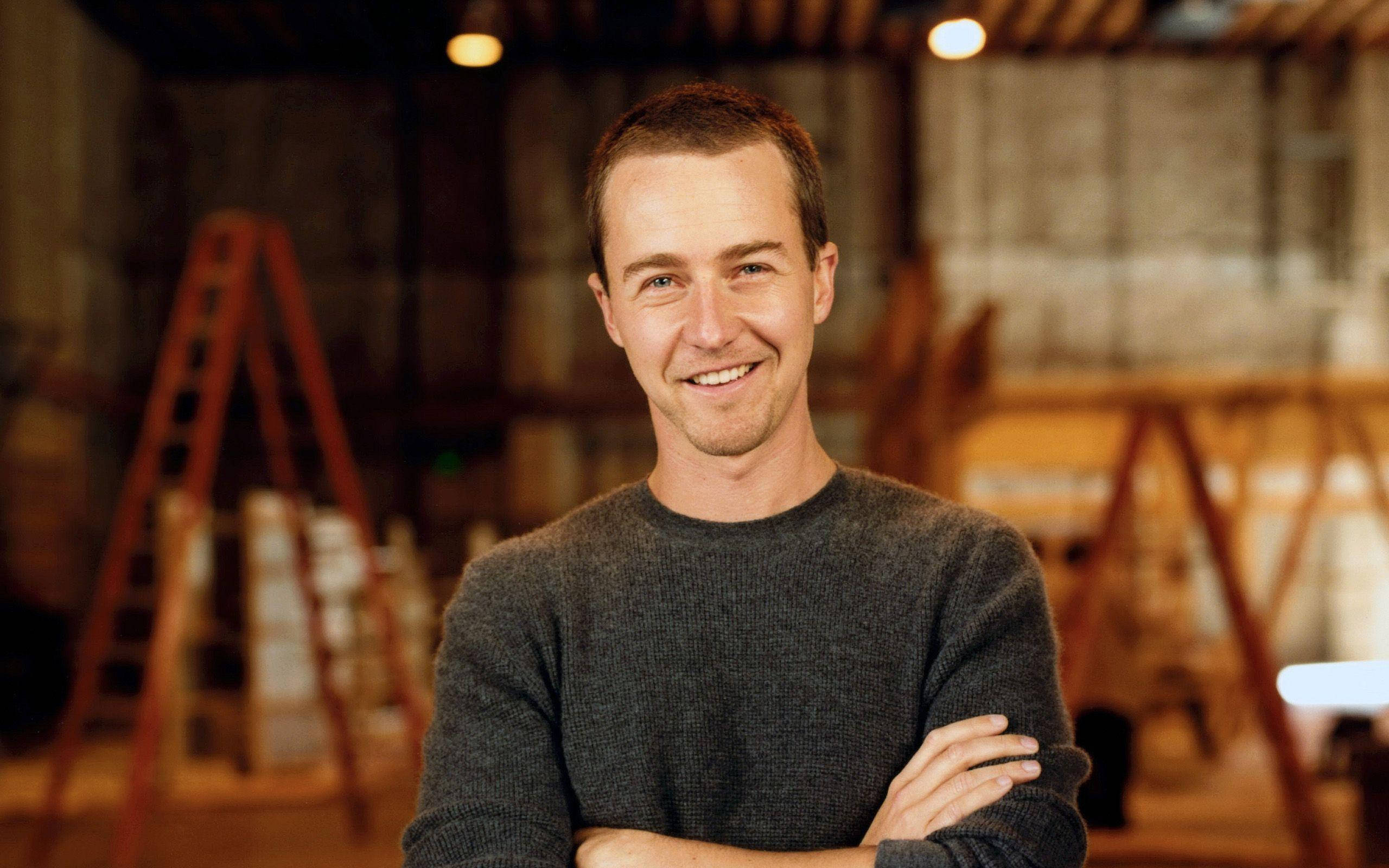 Edward Norton, gray sweater, antique warehouse, 2K Desktop Wallpaper