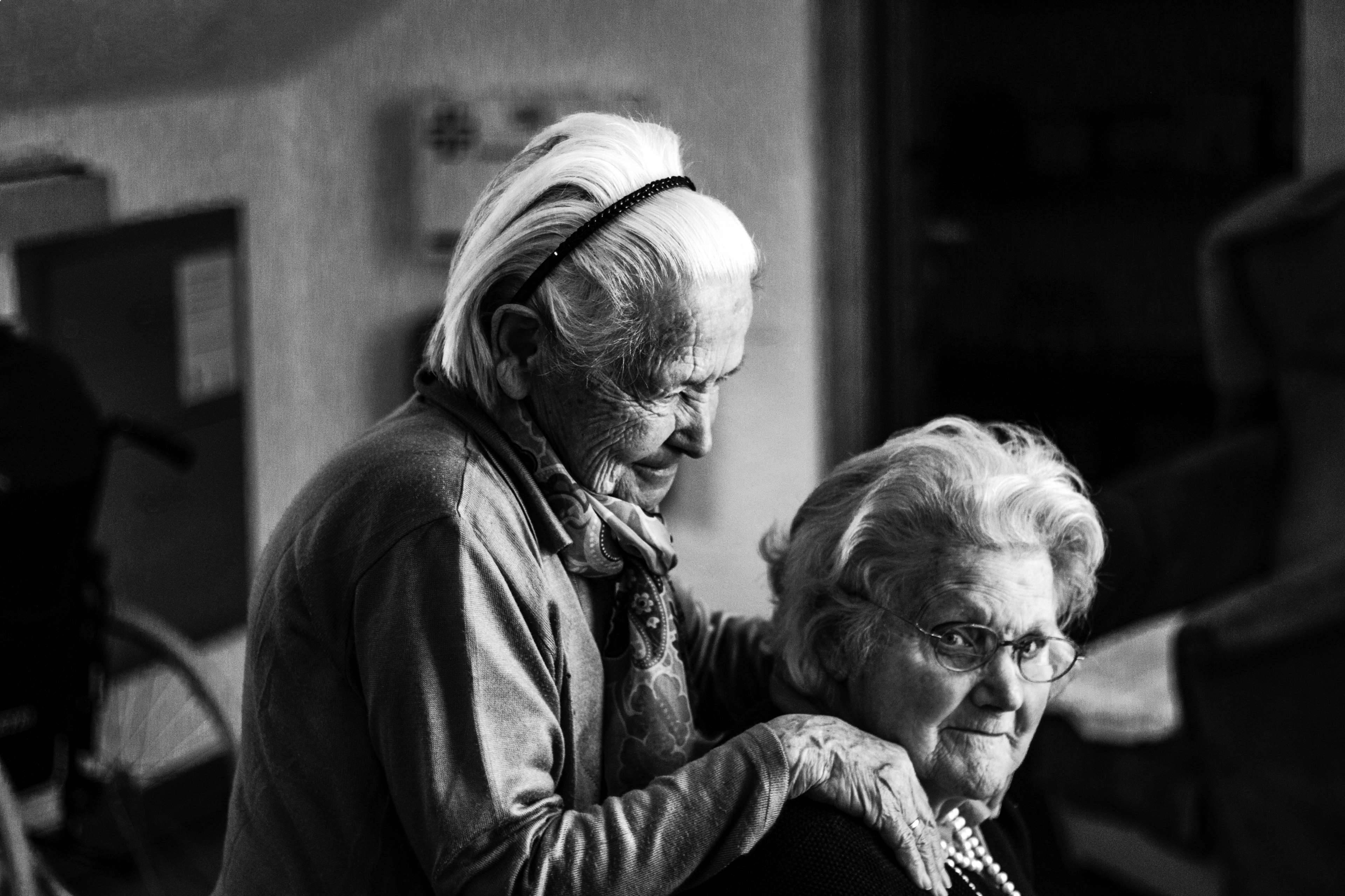 elderly woman, dimly lit room, tender moment, 4K Desktop Wallpaper