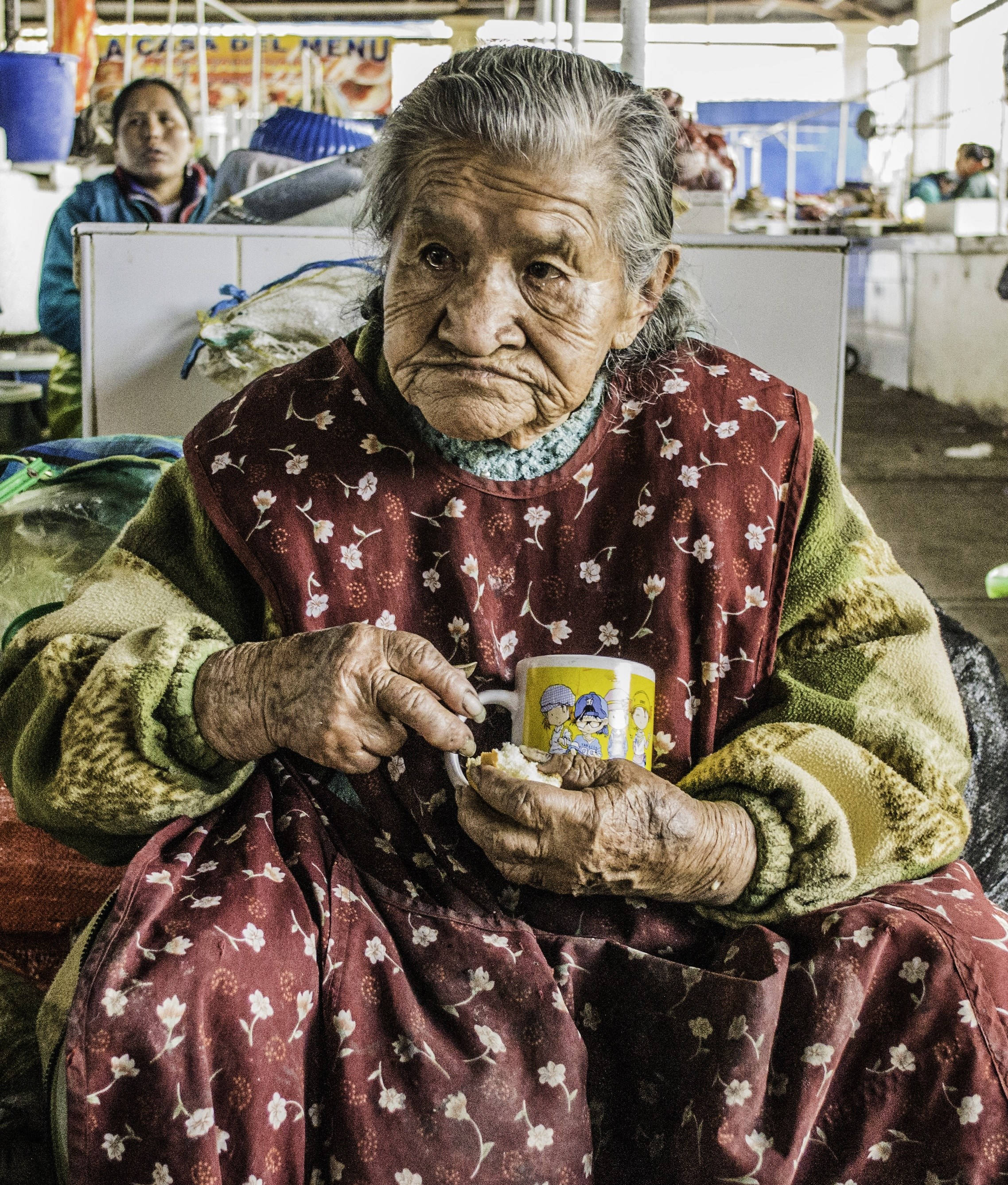 elderly woman, bustling market stall, bright daylight, 2K Phone Wallpaper