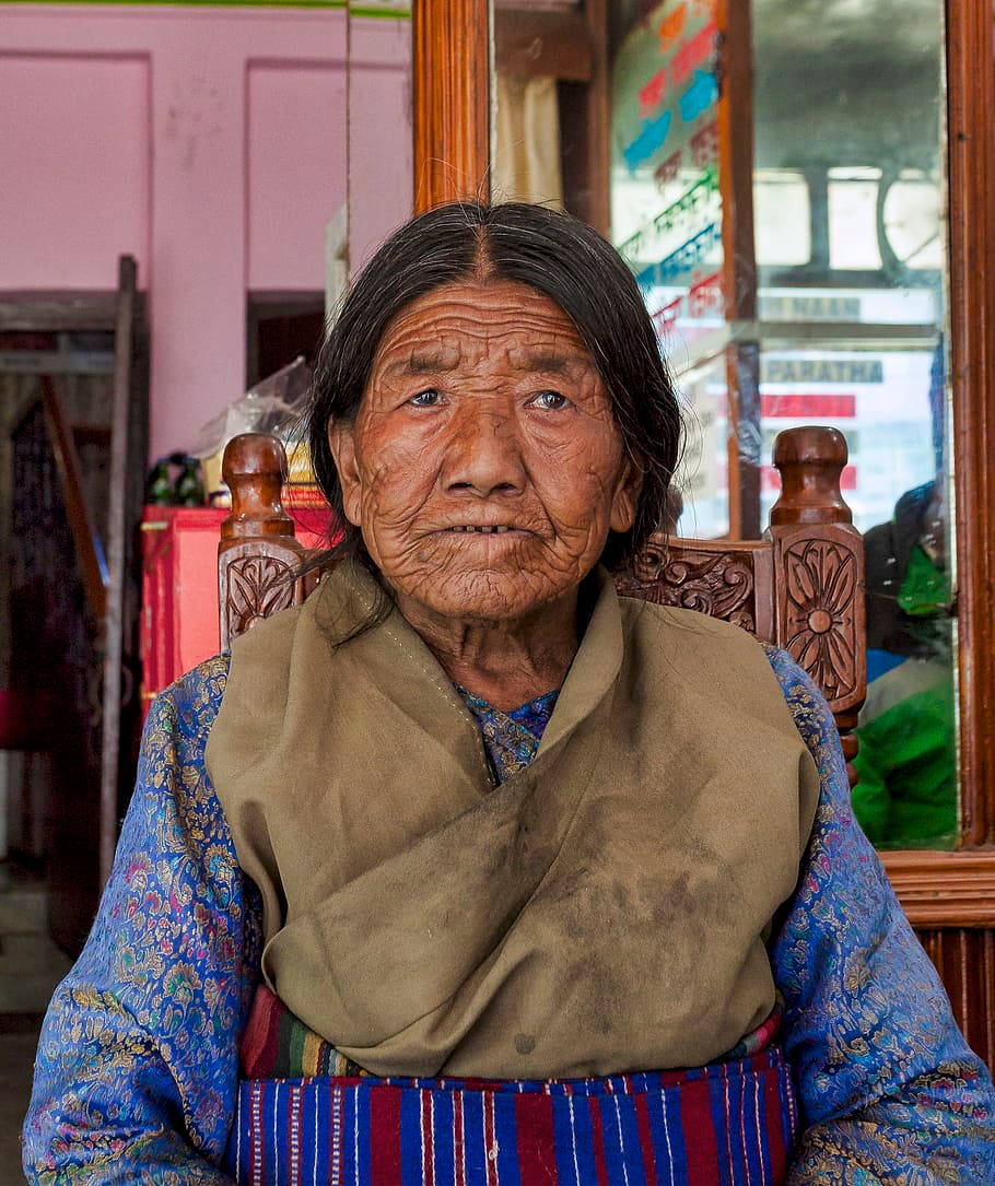 elderly woman, traditional blue dress, wooden chair, SD Phone Wallpaper