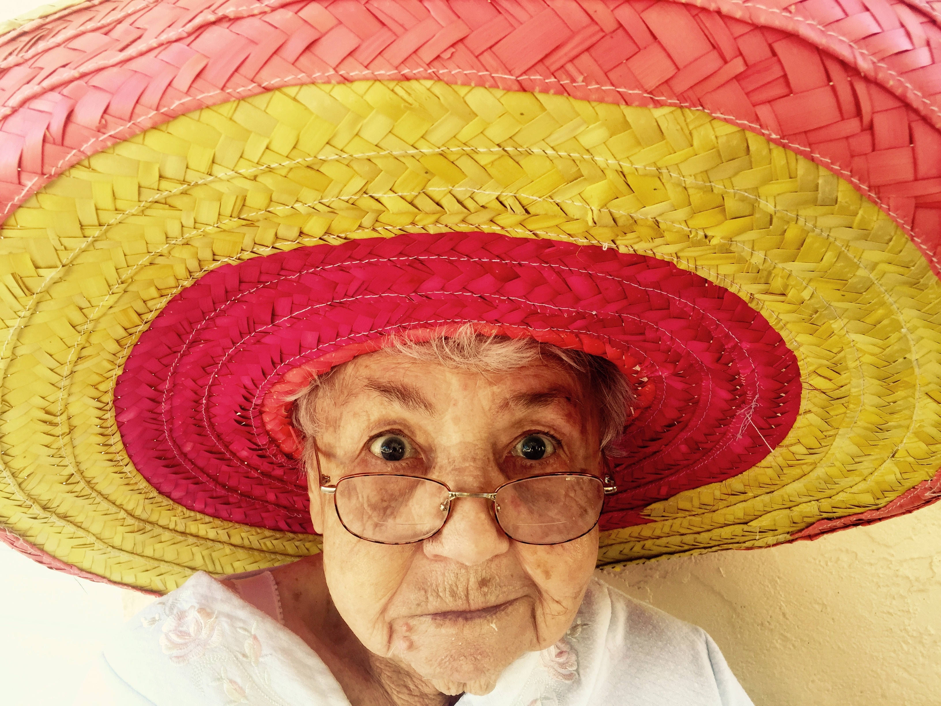 elderly woman, Mexican sombrero, vibrant pink, 2K Desktop Wallpaper