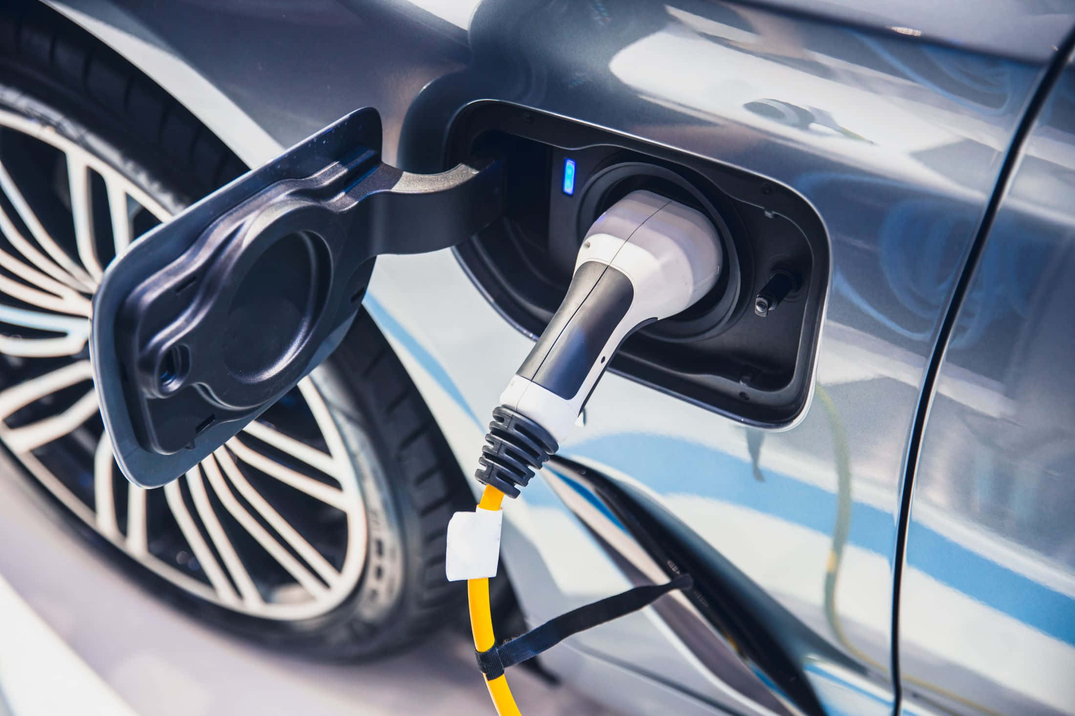 Sleek Electric Vehicle, bright yellow cable, charging, Full HD Desktop Wallpaper